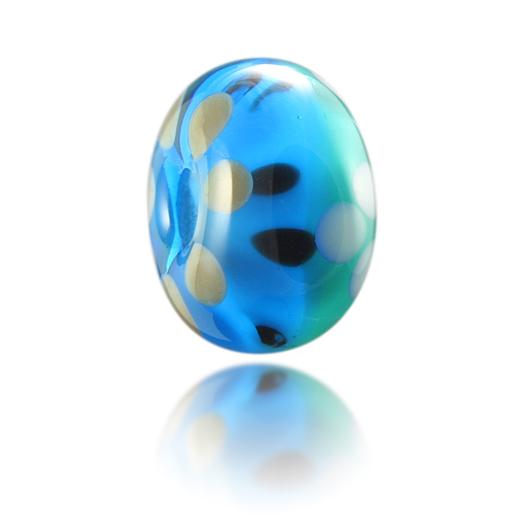 Turquoise and green transparent glass bead with white and black patterns, representing Putsborough Sands beach in North Devon.
