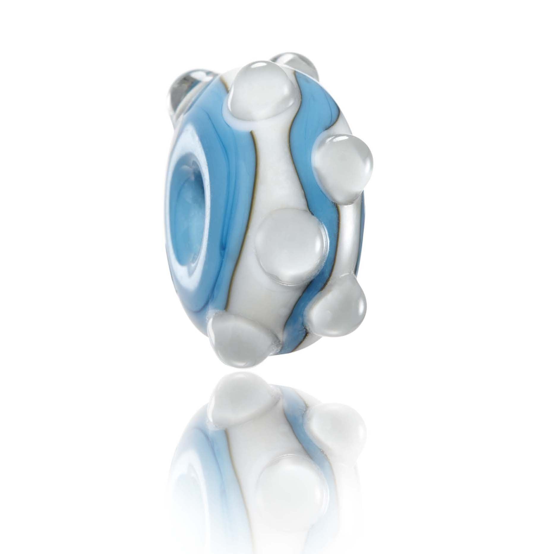 Blue and white striped and spotted glass bead representing Combesgate in Woolacombe North Devon.