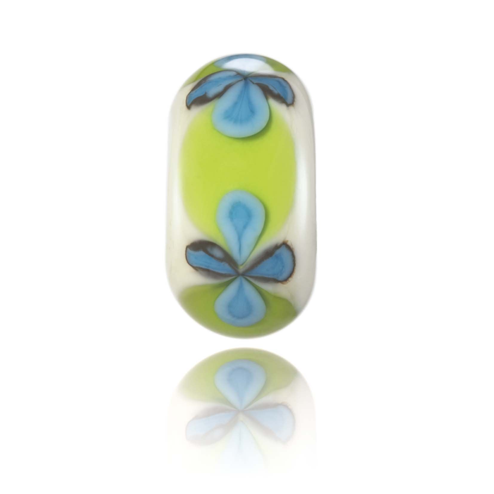Cream bead with green band and blue flowers on surface.