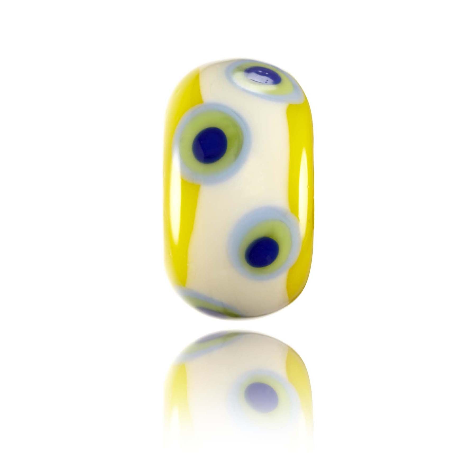 Yellow glass bead with cream and green and blue dot patterns.