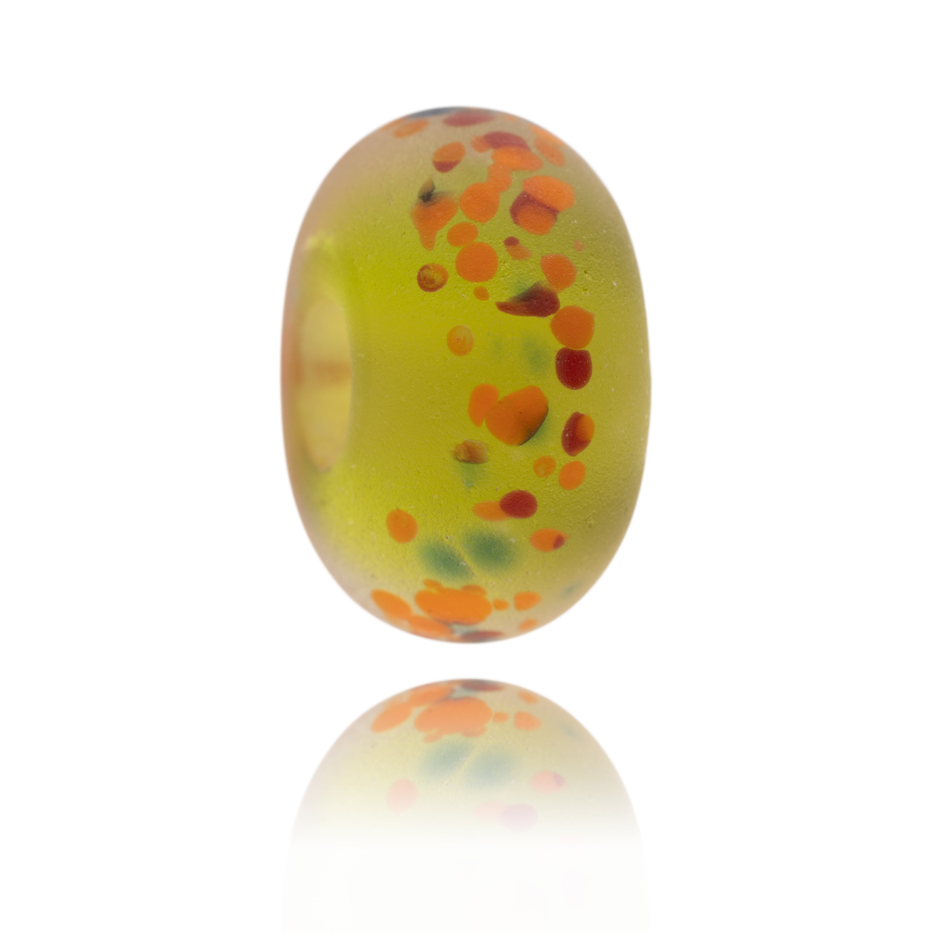 Green glass bead with red and orange dots on surfer.