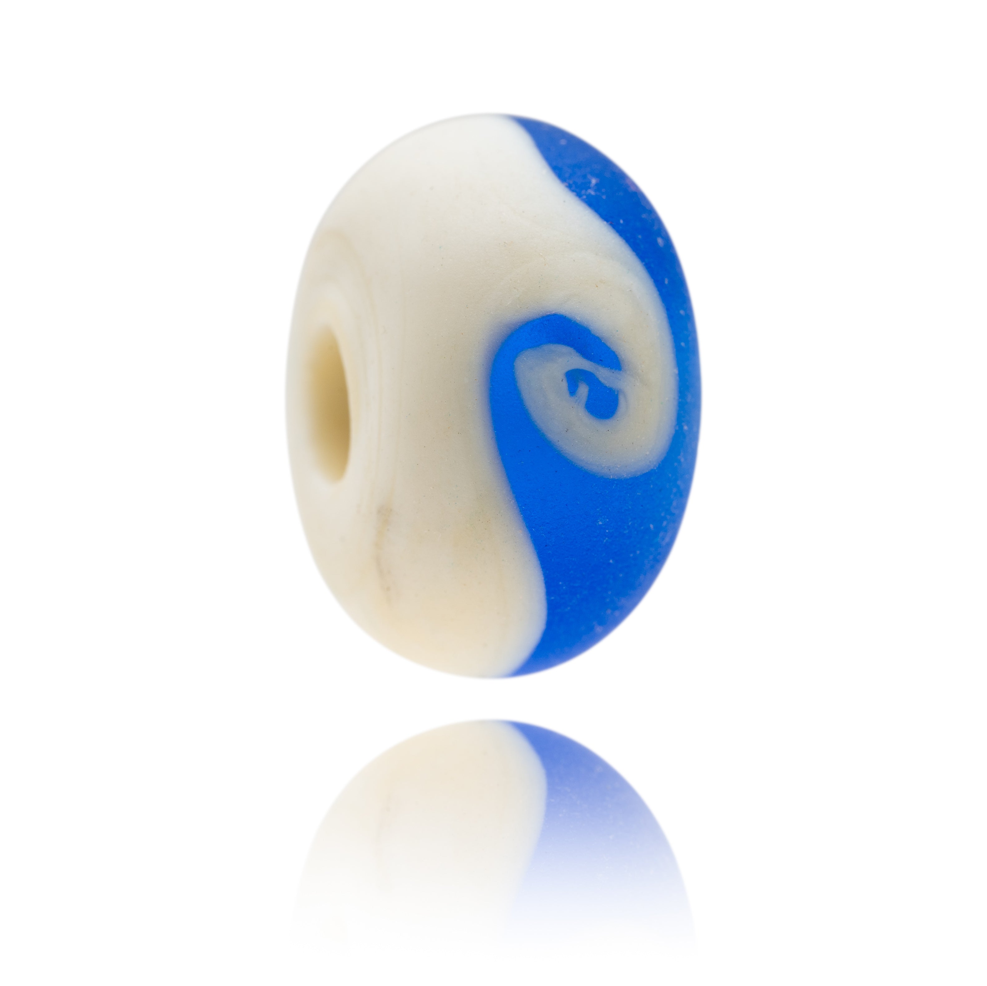 Blue and cream glass bead with matte surface representing Brancaster Beach in Norfolk.