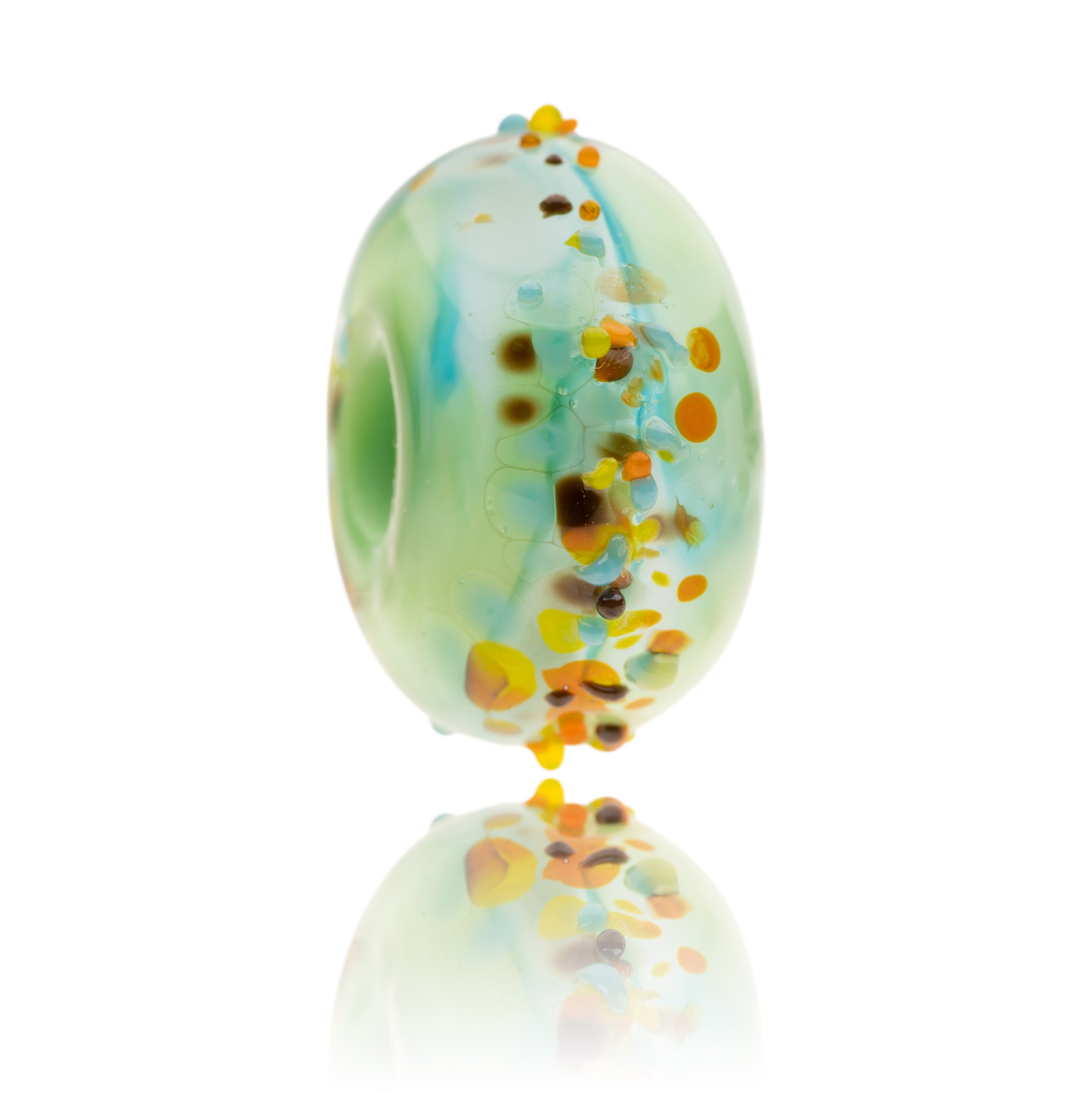 Green and blue swirling glass bead with brown, orange and yellow texture glass on surface. Representing the Beaumont Countryside Centre in Braunton, North Devon.