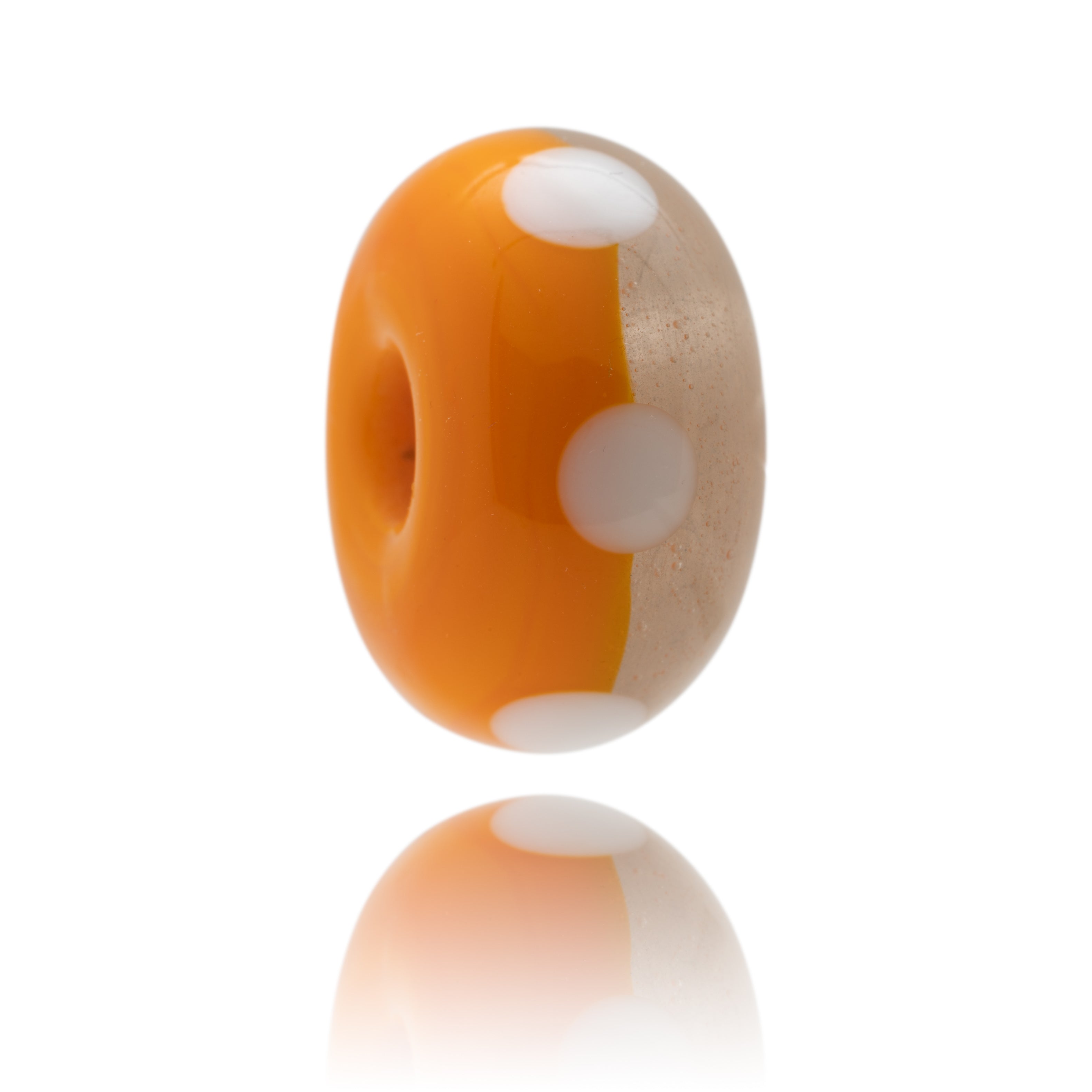 Orange and white spotted glass lamp work bead for Camber Sands In Kent.