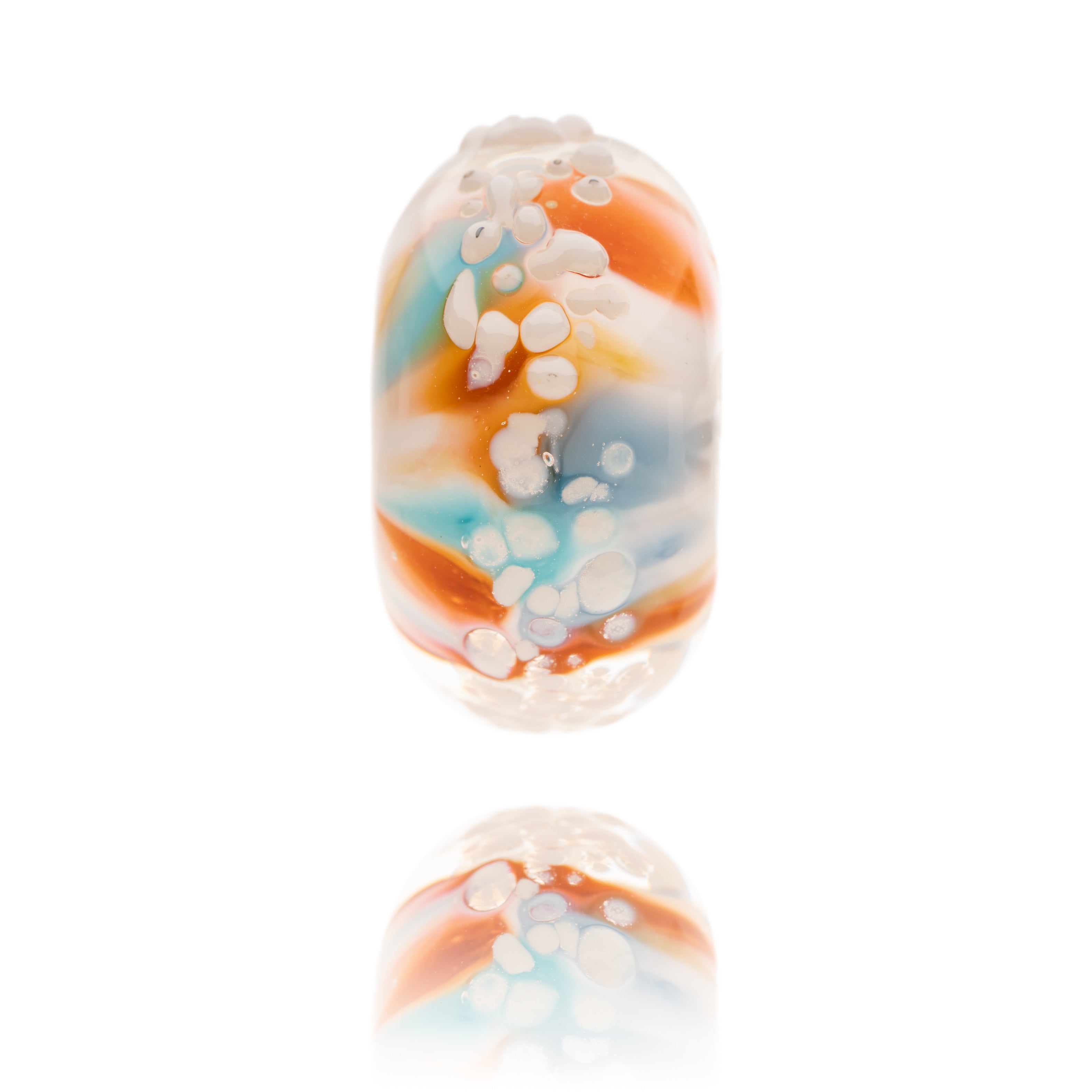 Blue, red and white glass bead with white raised surface texture, representing Cayton Bay in Yorkshire