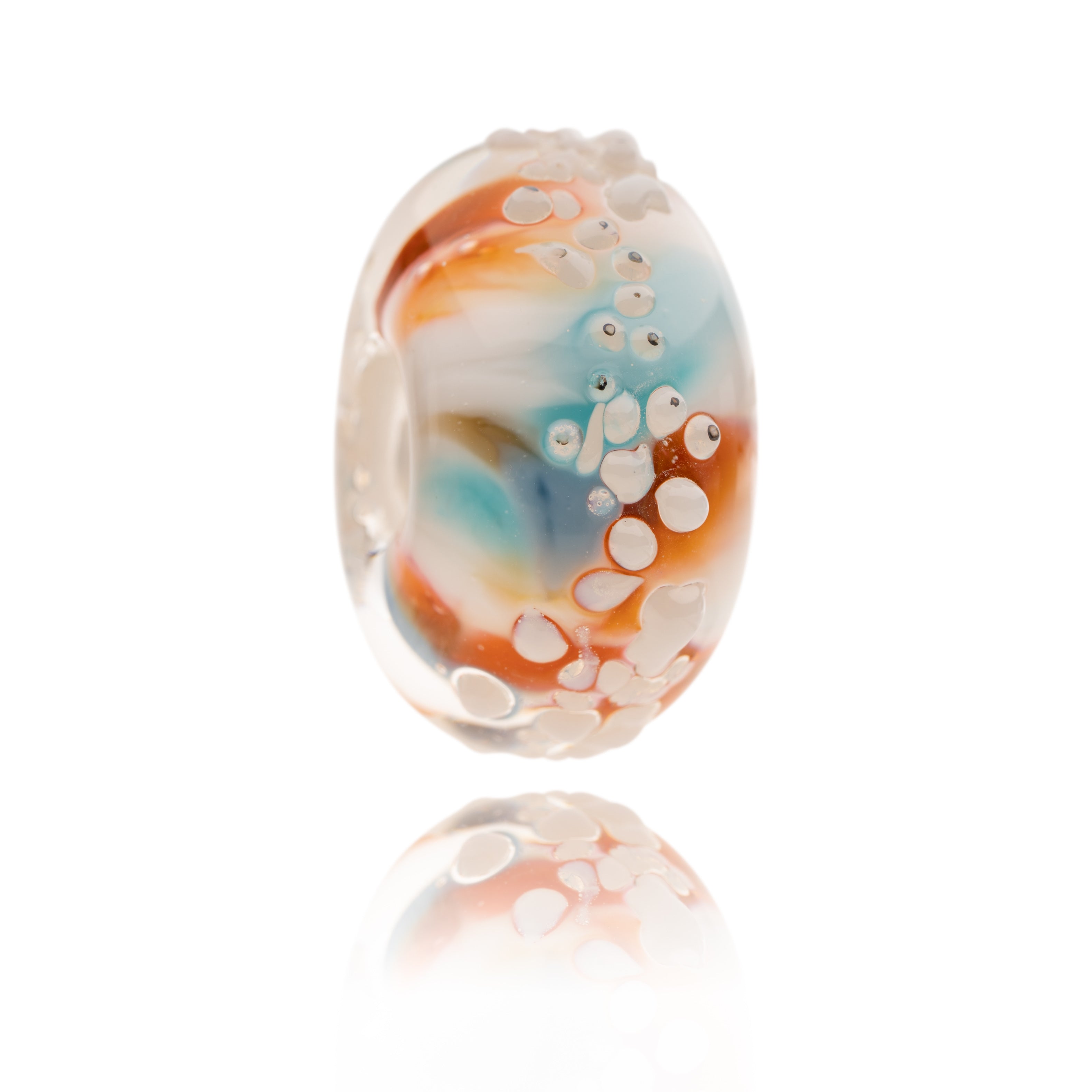 Blue, red and white glass bead with white raised surface texture, representing Cayton Bay in Yorkshire