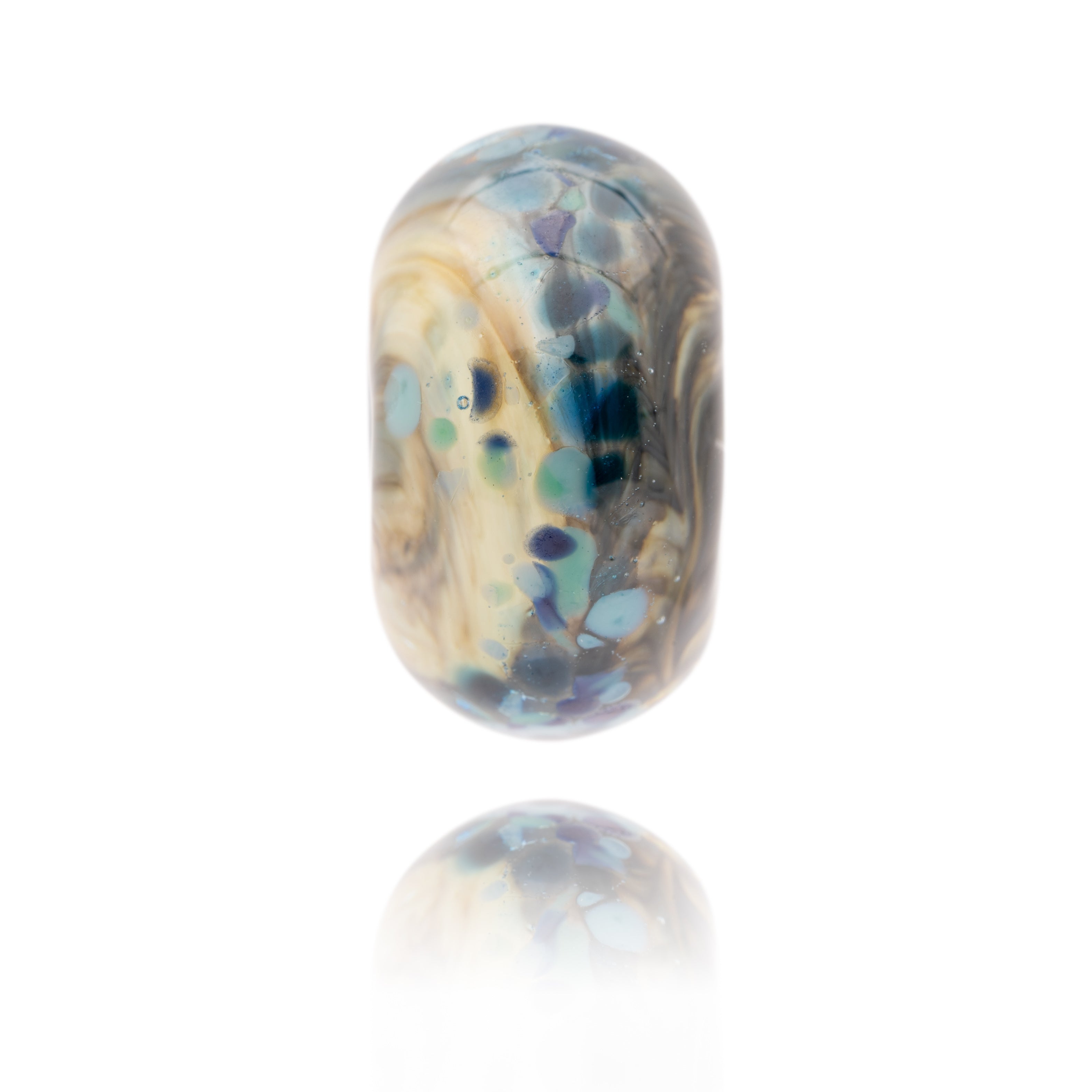 Born and cream swirling glass bead with blue spots on surface representing Cresswell Beach in Northumberland.