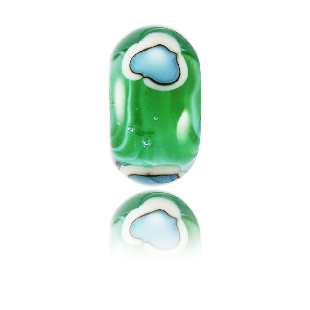 Green swirling glass bead with surface pattern of lighthouse island representing Godrevy in Cornwall.
