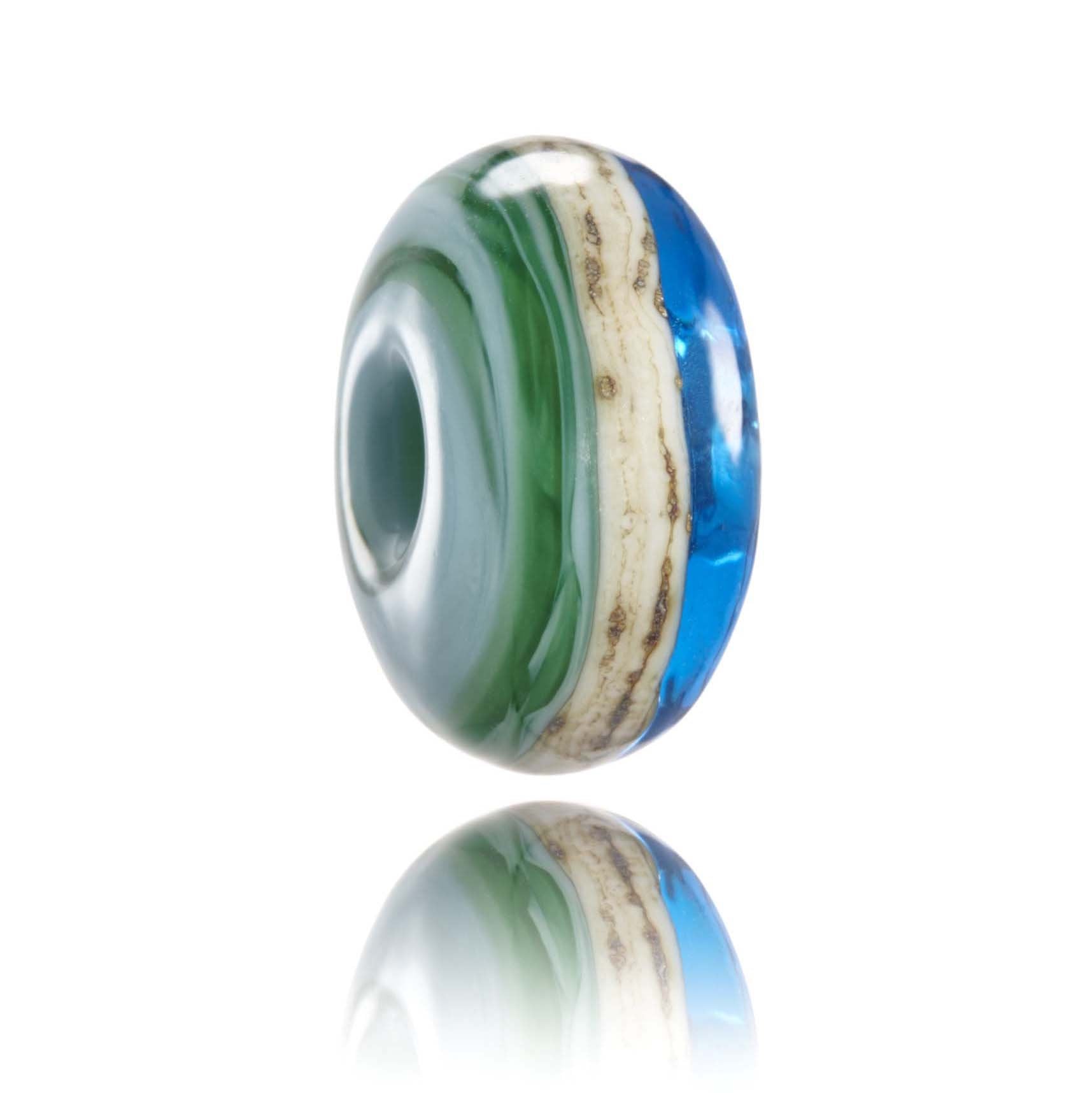Green and blue glass bead with a sandy stripe around the middle. Representing Padstow in Cornwall, UK.