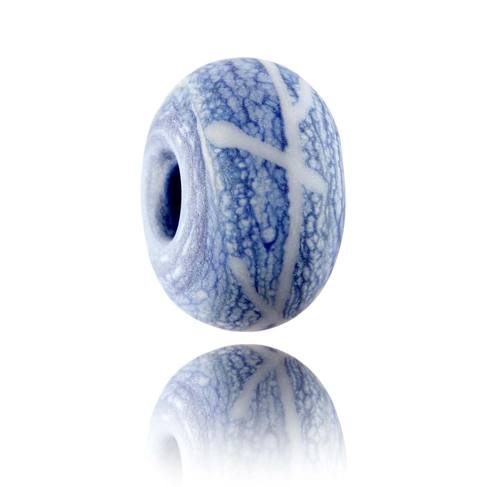 Blue and white mottled glass bead representing the fishing harbour village of Polperro in Cornwall.