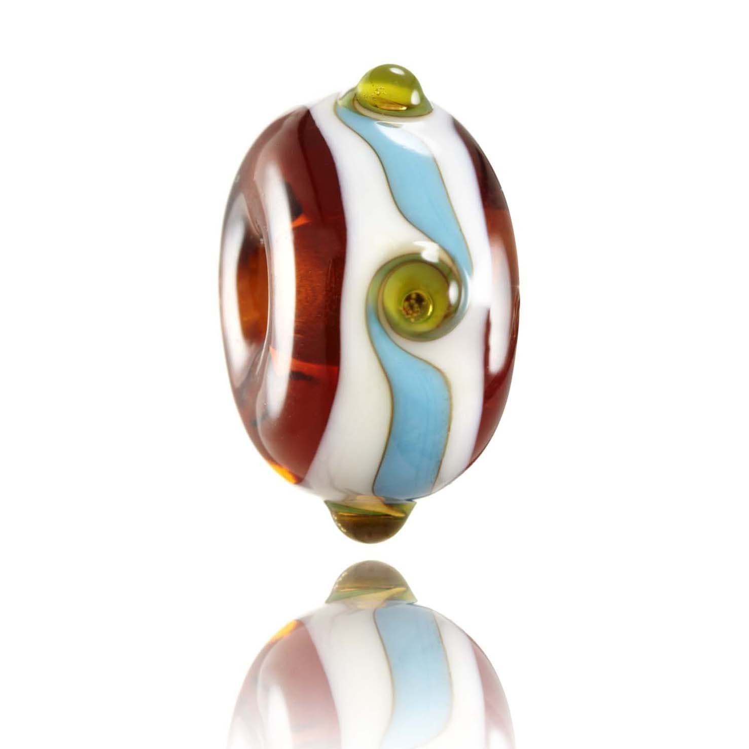 Brown, white and blue patterned las bead with raised green dots representing Porthcurno Beach in West Cornwall, UK.