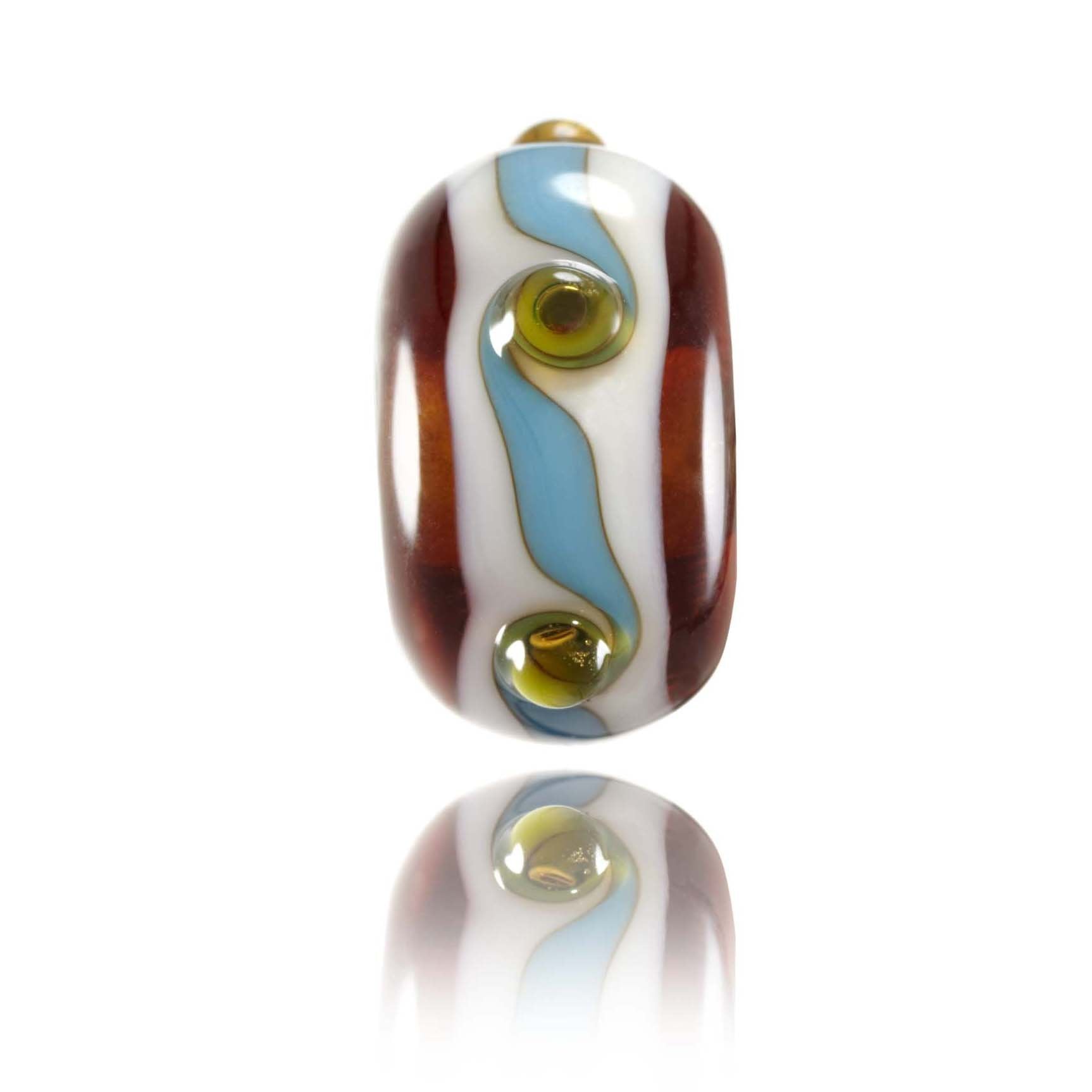 Brown, white and blue patterned las bead with raised green dots representing Porthcurno Beach in West Cornwall, UK.