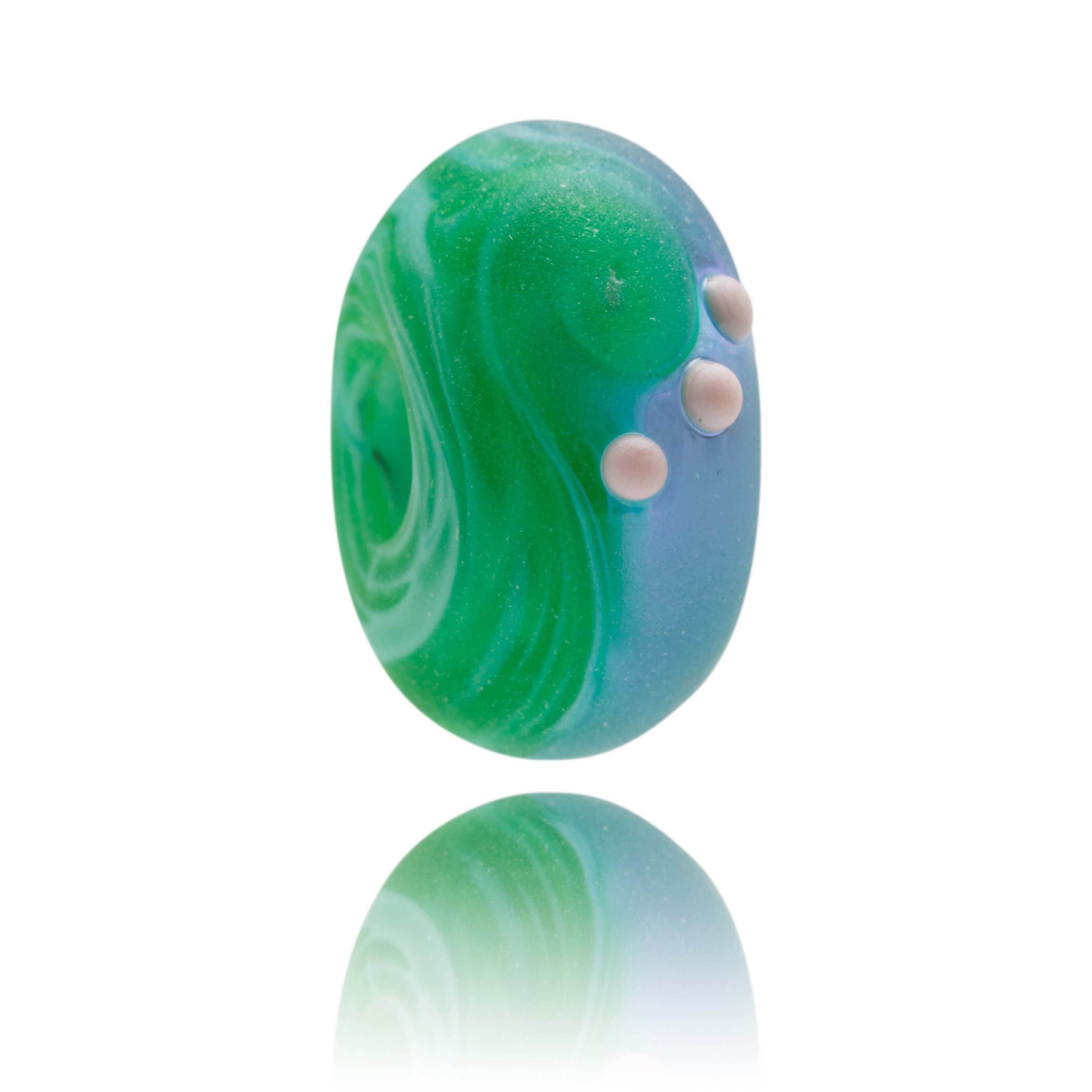 Green and purple glass bead representing Porth Neigwl beach in Wales.