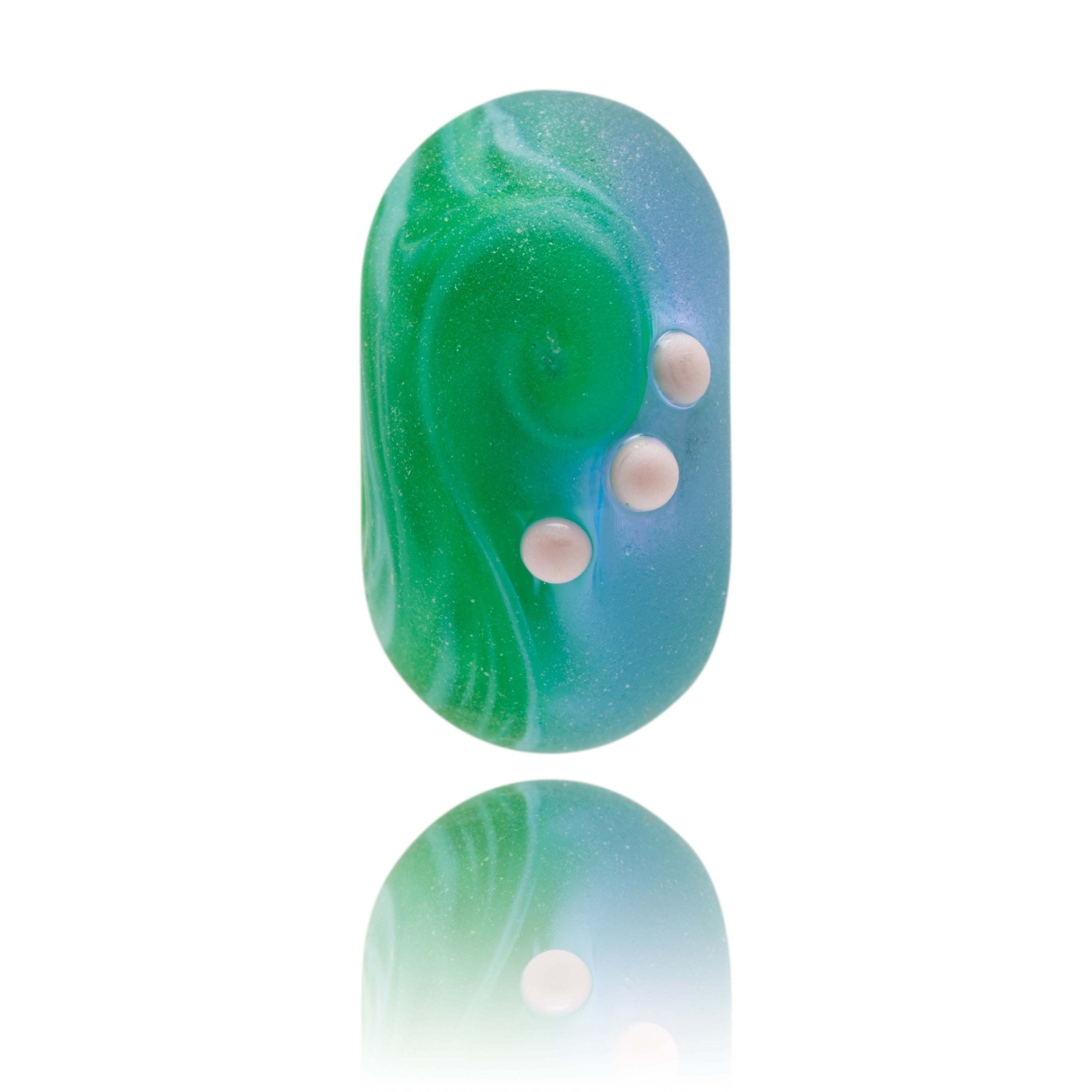 Green and purple glass bead representing Porth Neigwl beach in Wales.
