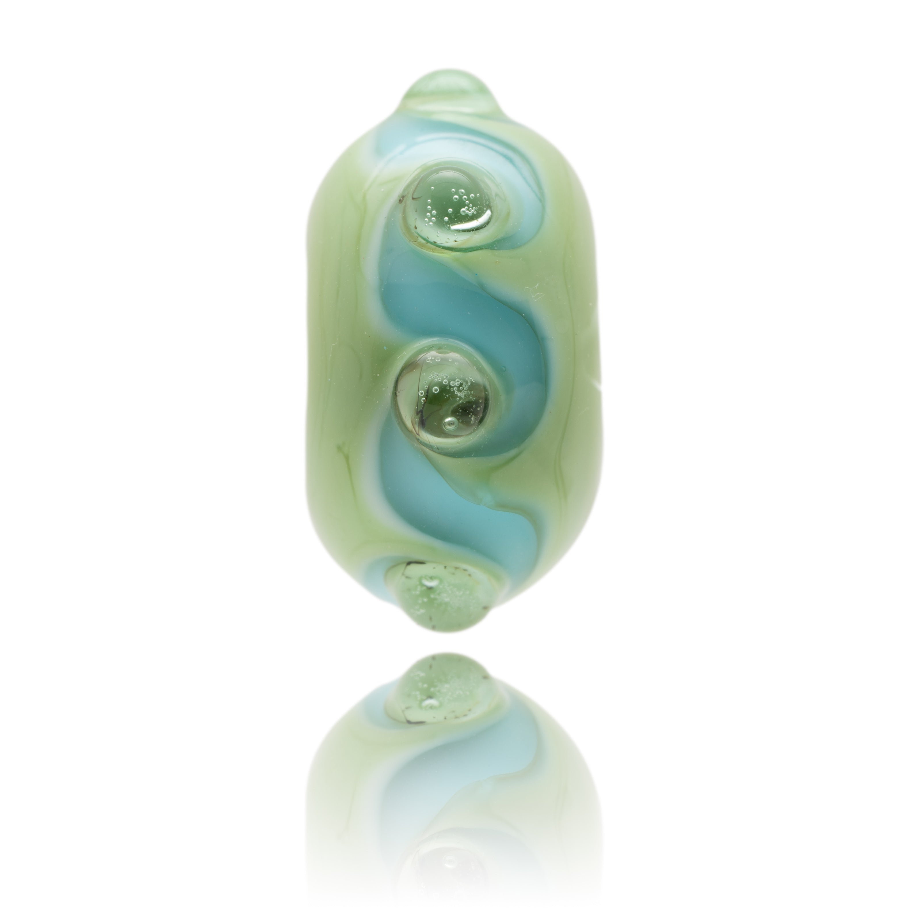 Pale green glass bead with blue swirl patter and raised glass dots on the surface. Representing Porthluney Beach in south Cornwall, UK.