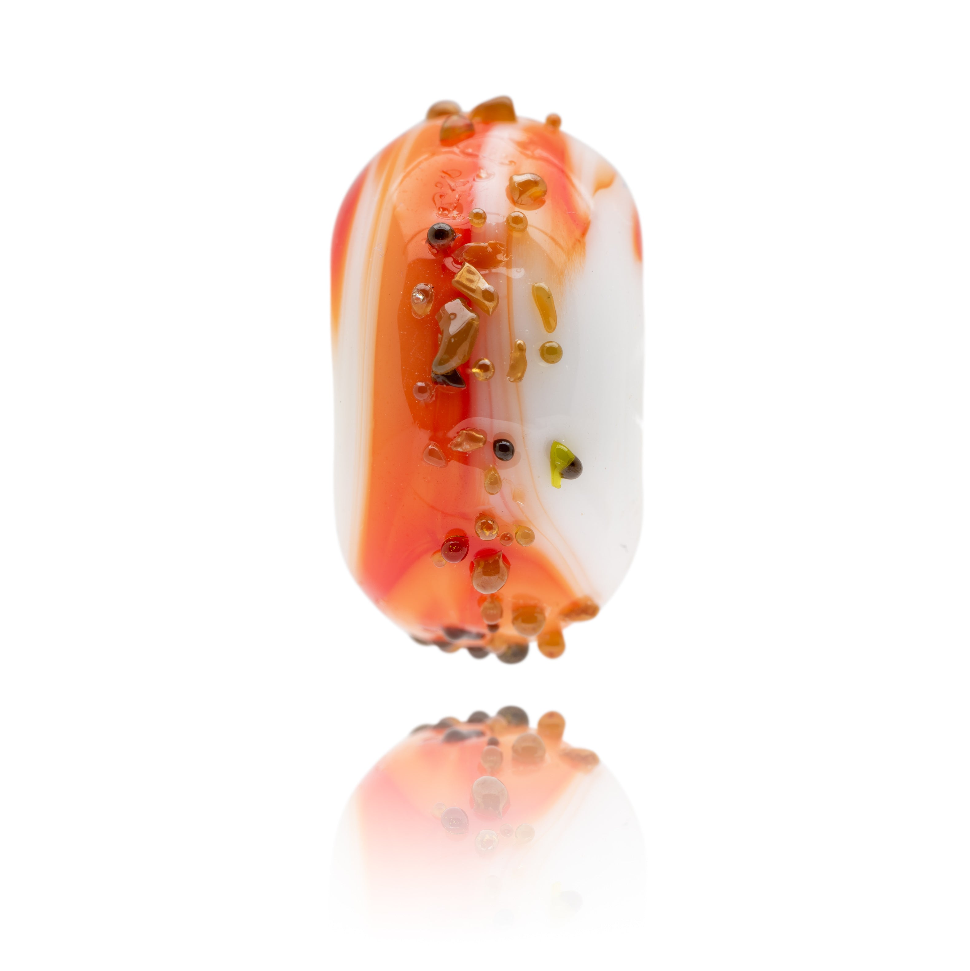 Red, white and orange swirling glass bead with raised specks of glass on the surface. Representing Portland Bill in Dorset, UK.