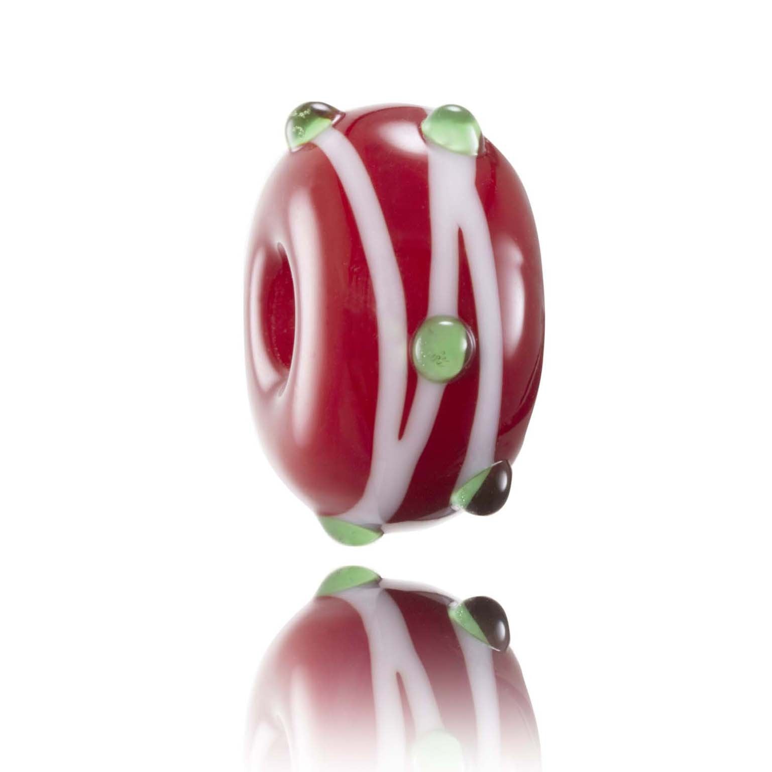 Red glass bead with white stripes going around in and green dots representing Rhosilli beach in Wales.