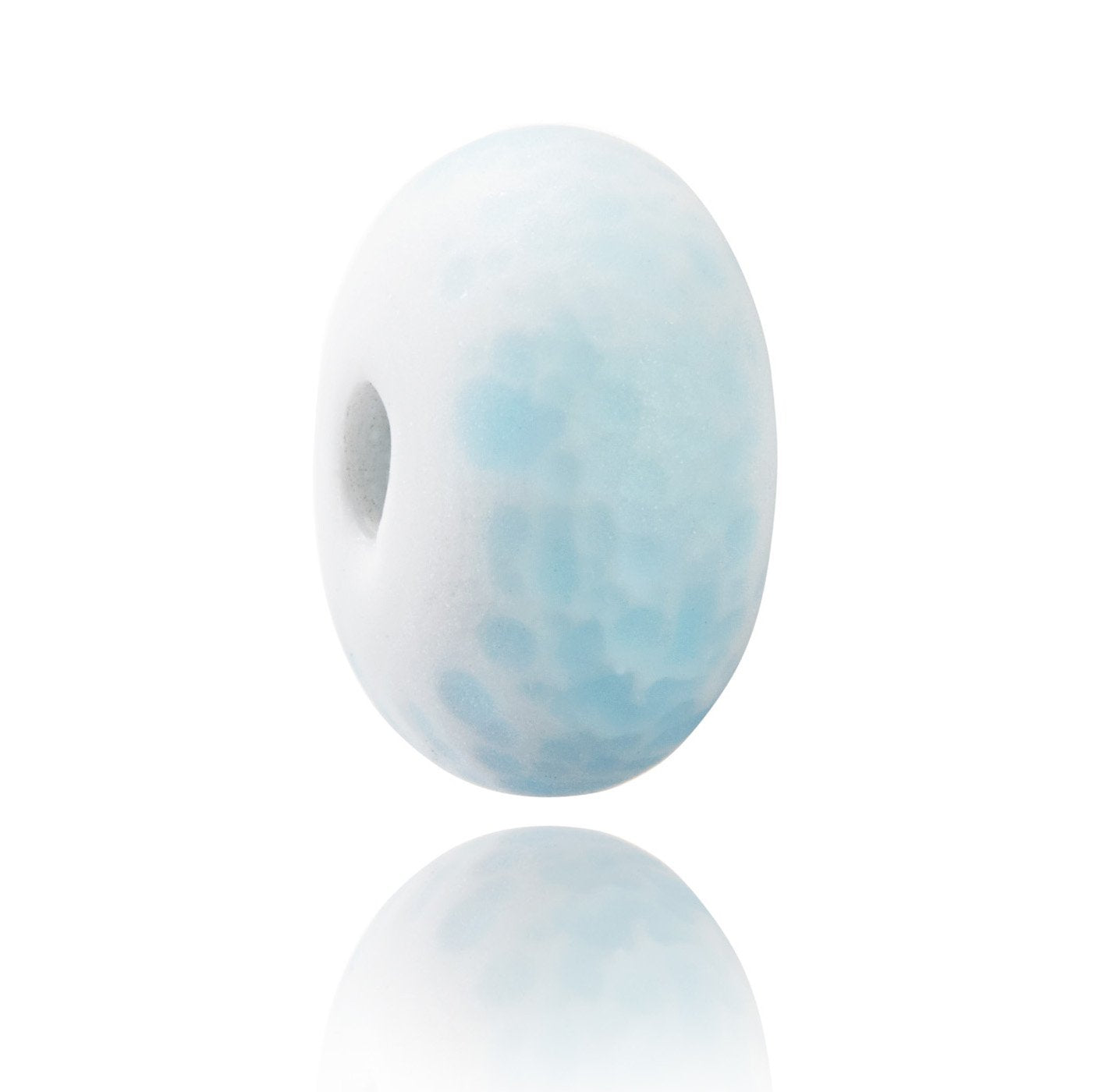 White frosted glass baed with pale blue dots on the surface, representing powder snow on the mountains.