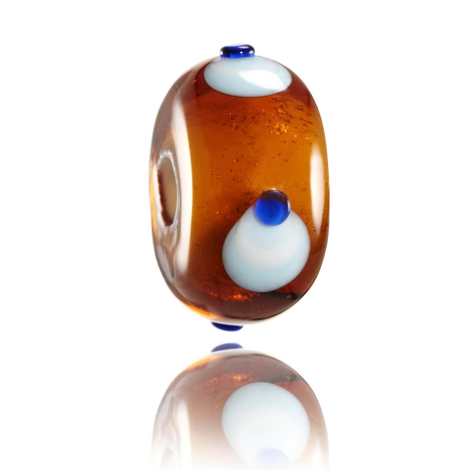 Brown amber glass bead with blue dots for Sumatra, Indonesia.