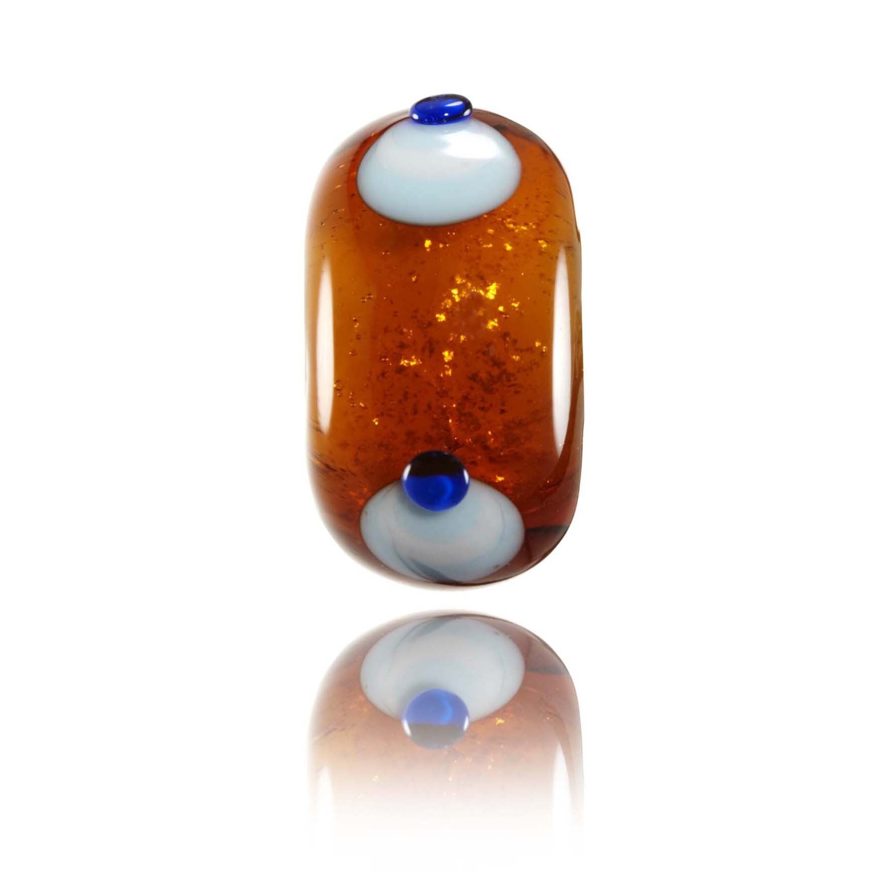 Brown amber glass bead with blue dots for Sumatra, Indonesia.