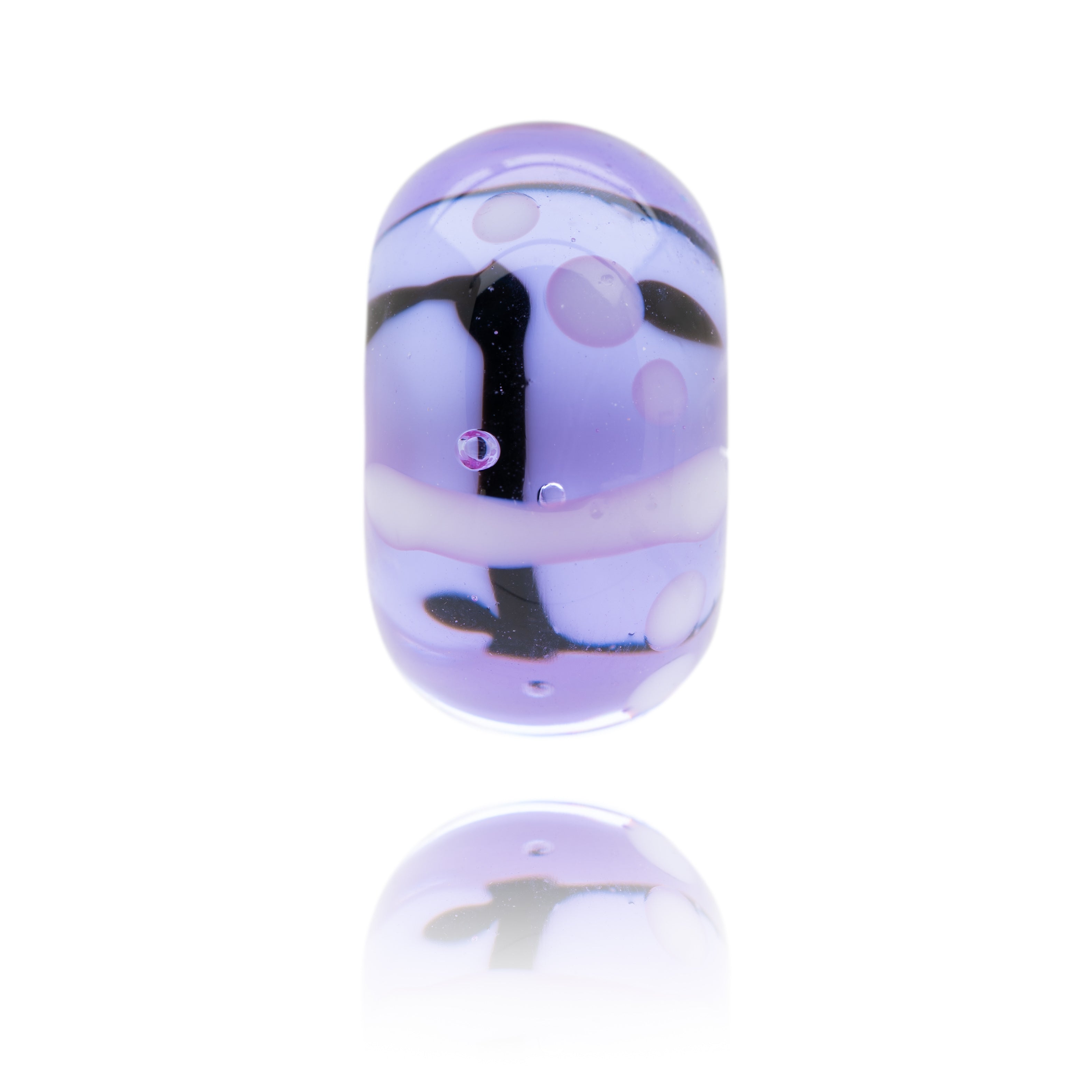 Glass bead in a transparent lavender colour with black lines representing Southwold in Suffolk.