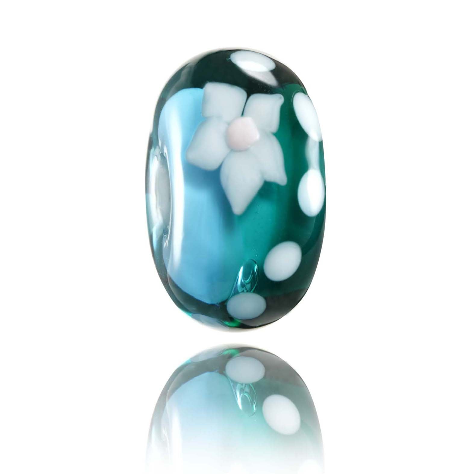 Teal and blue glass bead with white flower pattern on the surface for Tahiti island in Polynesia.