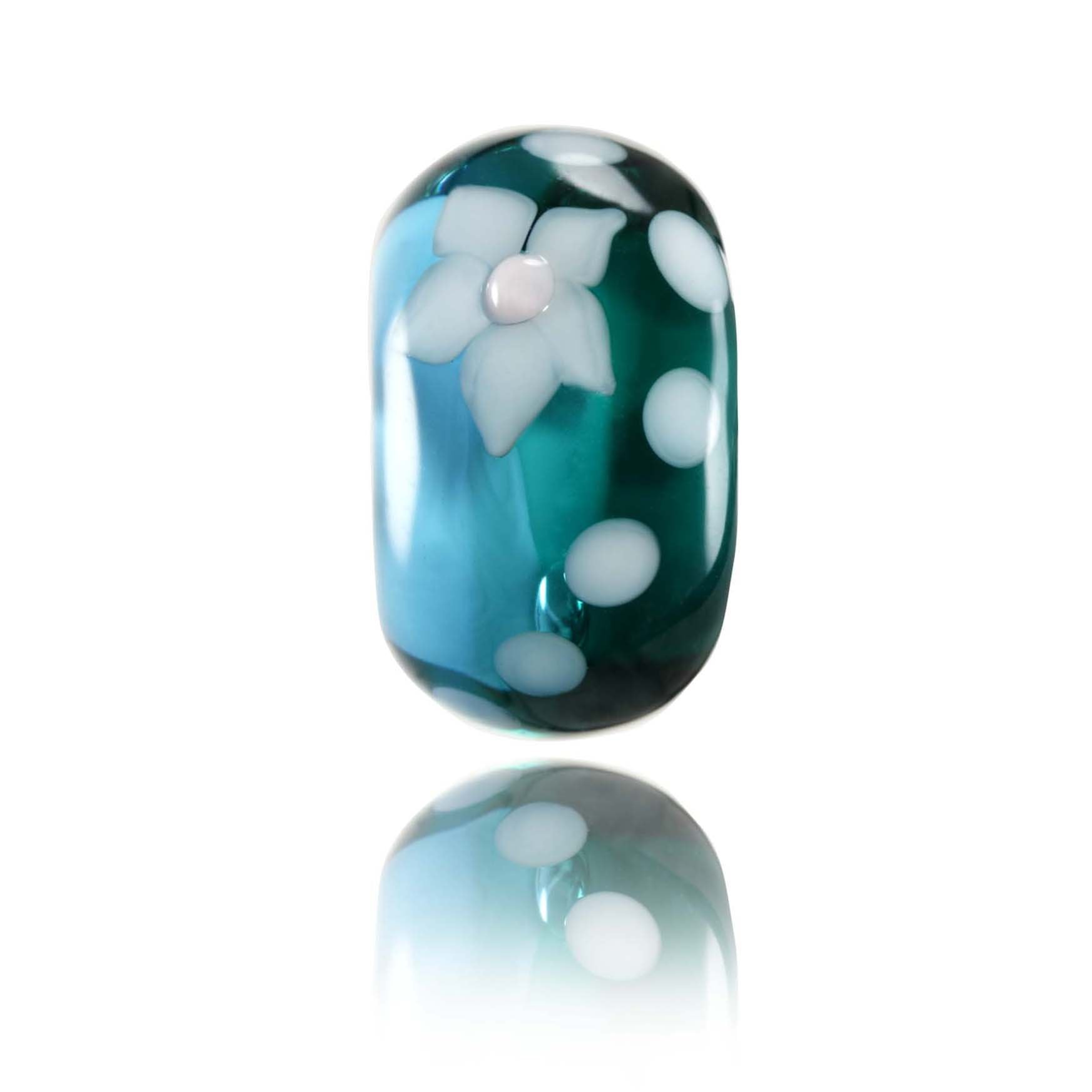 Teal and blue glass bead with white flower pattern on the surface for Tahiti island in Polynesia.