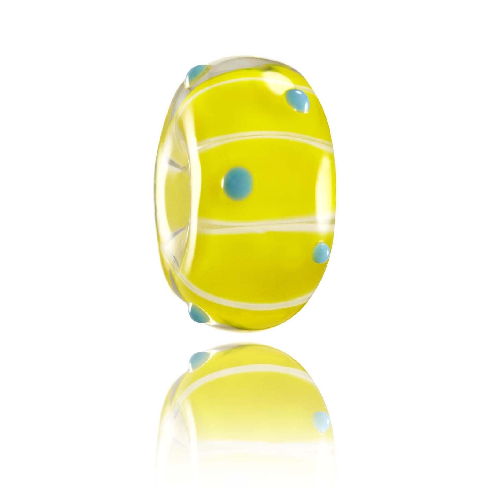 Bright yellow glass bead with blue dots on the surface, for Tallow Beach in Australia.