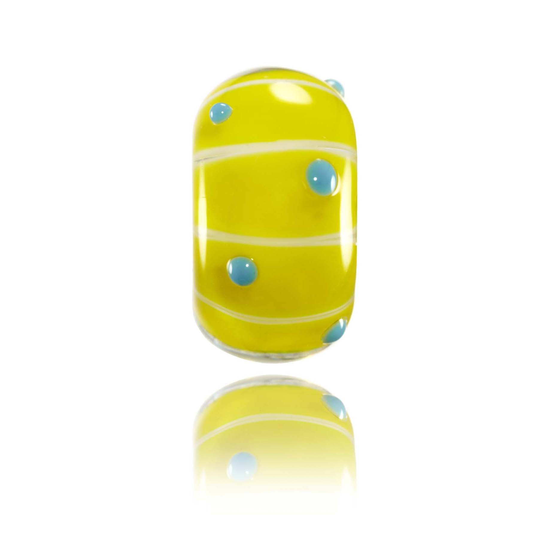 Bright yellow glass bead with blue dots on the surface, for Tallow Beach in Australia.