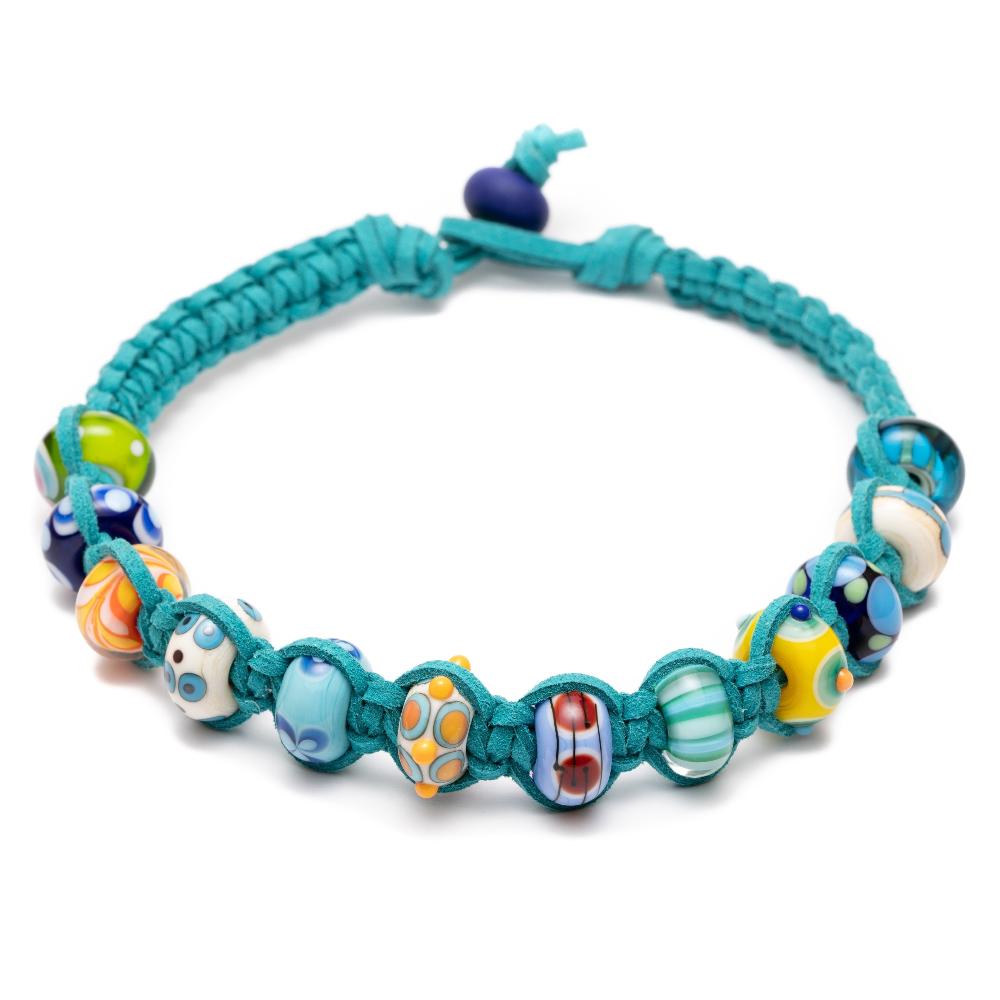 Colourful handmade murano glass beads that represent travel destinations and beaches from across the world made up onto a vegan suede cord choker necklace in a teal color.