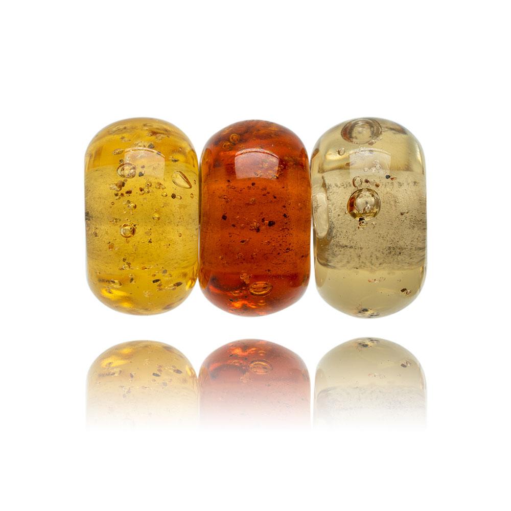 Amber trio of glass sand beads with grains of sand in the glass.