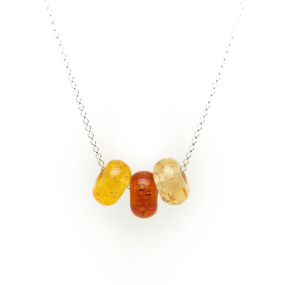 Amber trio of glass sand beads with grains of sand in the glass on a silver chain necklace.