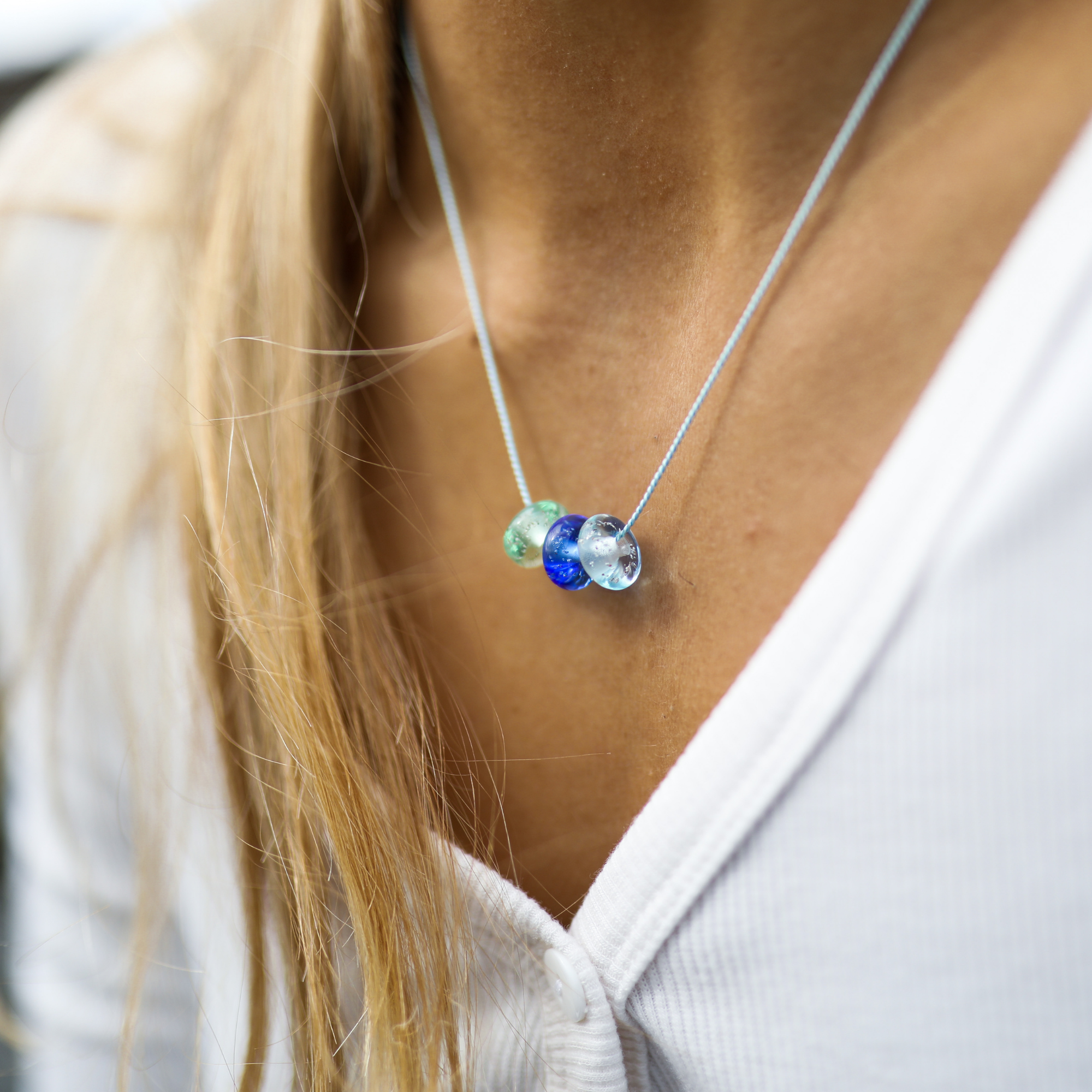 Beach drop glass bead necklace on silk cord in blues.