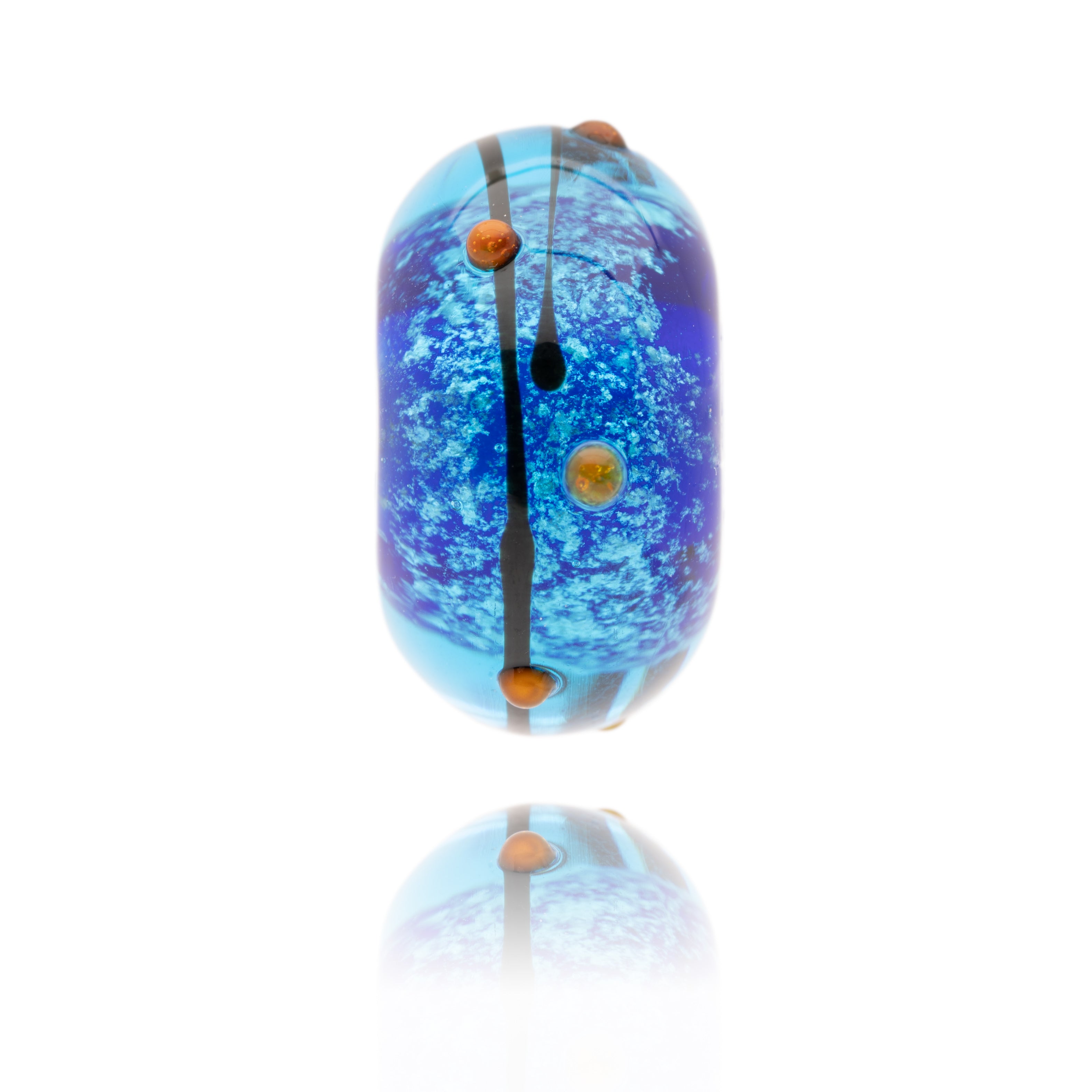 Shimmering blue glass bead with black stripes and red dots on surface, representing Blackpool Pleasure Beach.