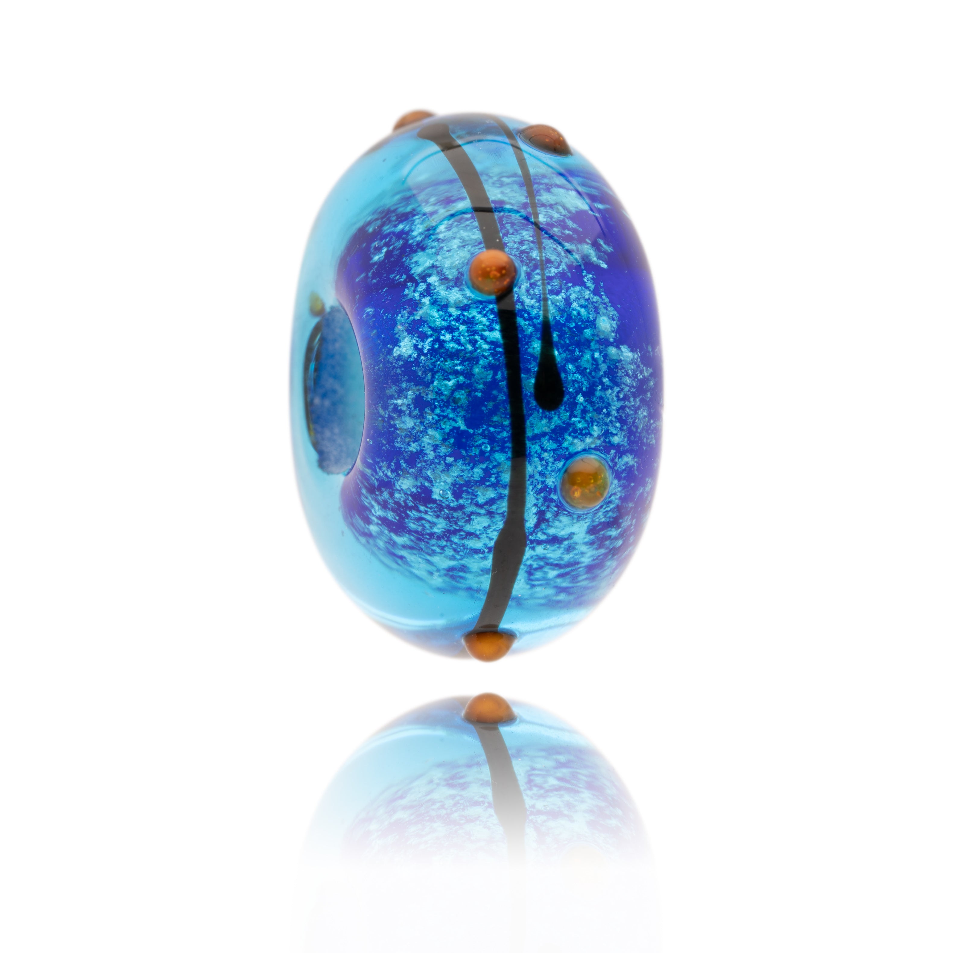 Shimmering blue glass bead with black stripes and red dots on surface, representing Blackpool Pleasure Beach.