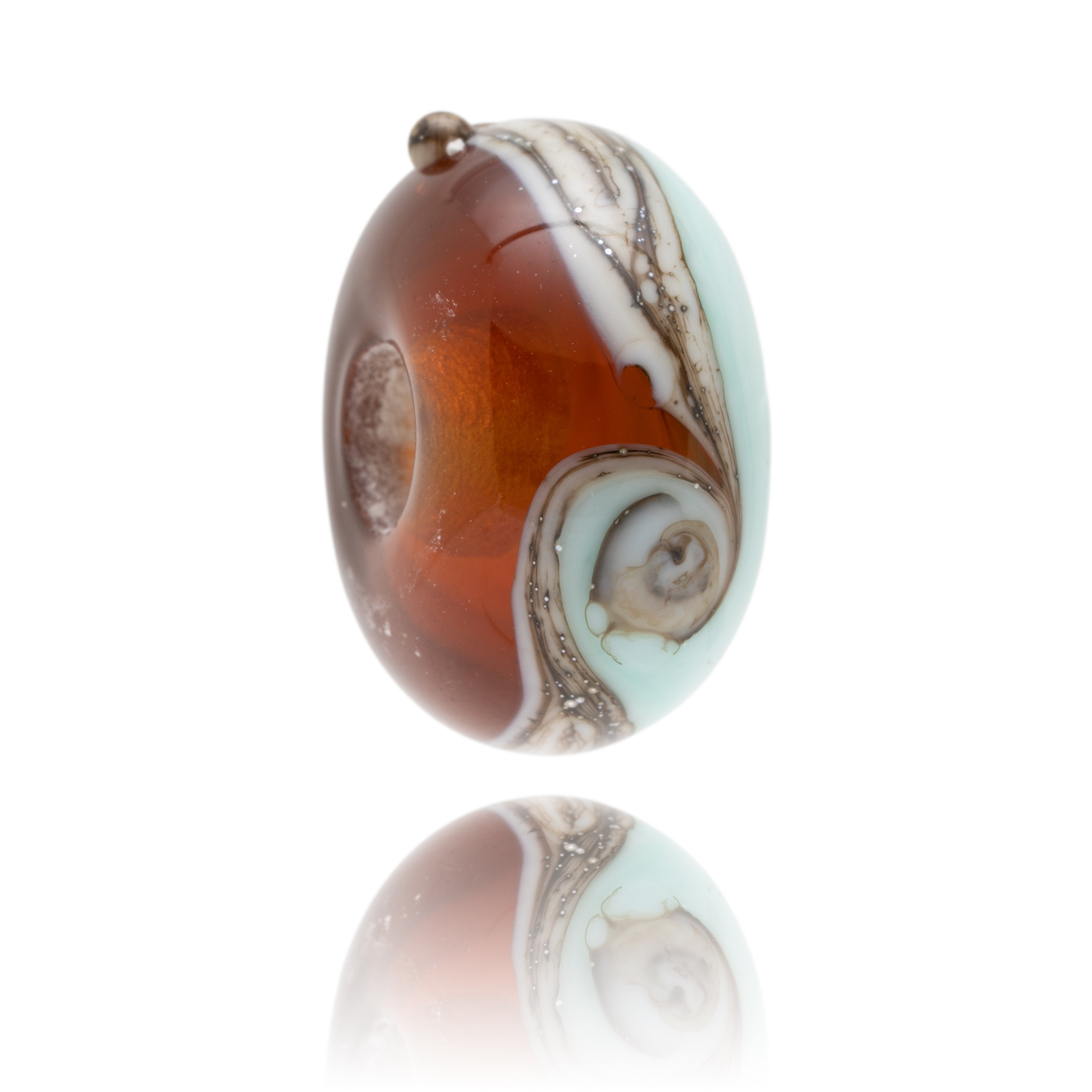 Brown and green swirling glass bead representing Blackpool sands beach in South Devon.