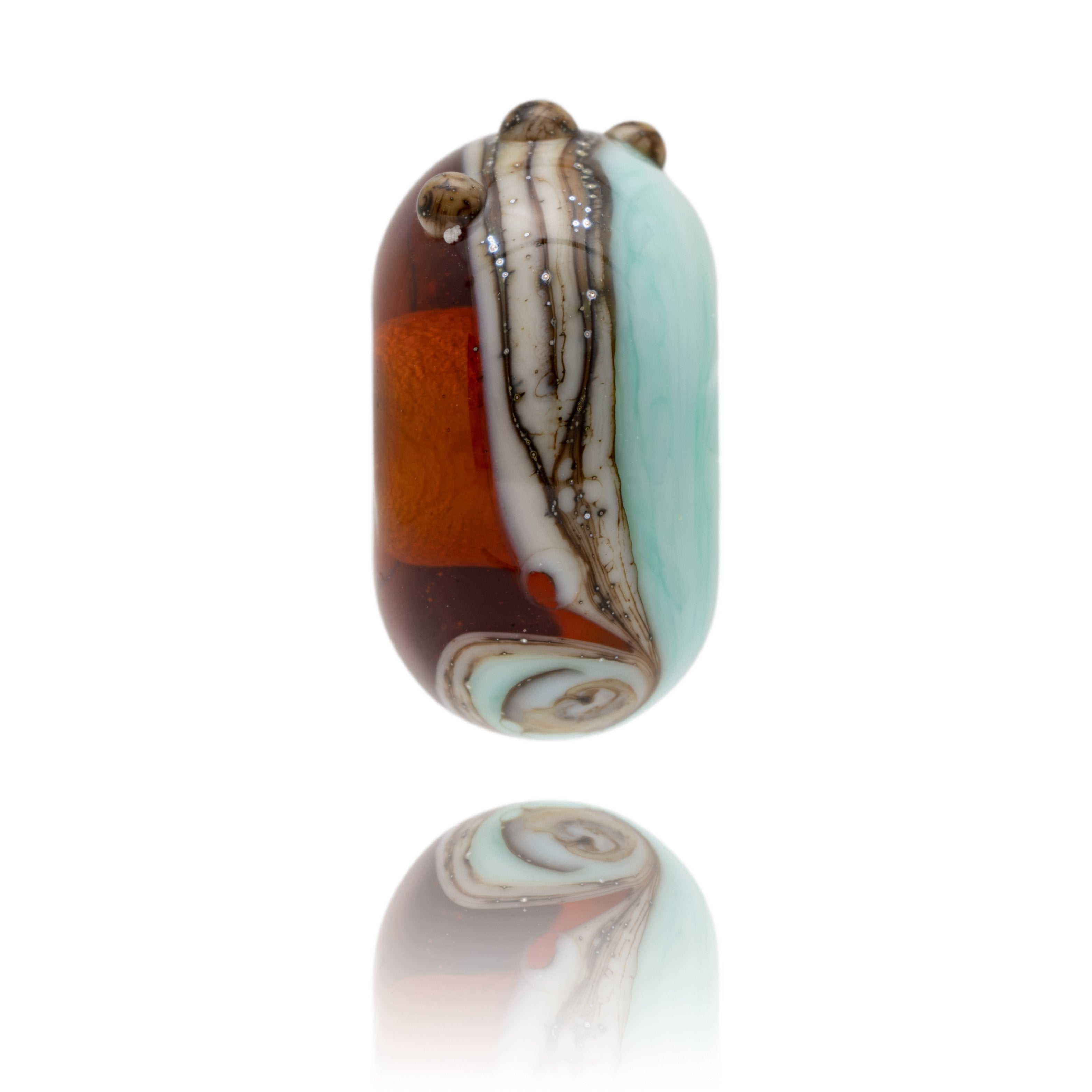 Brown and green swirling glass bead representing Blackpool sands beach in South Devon.