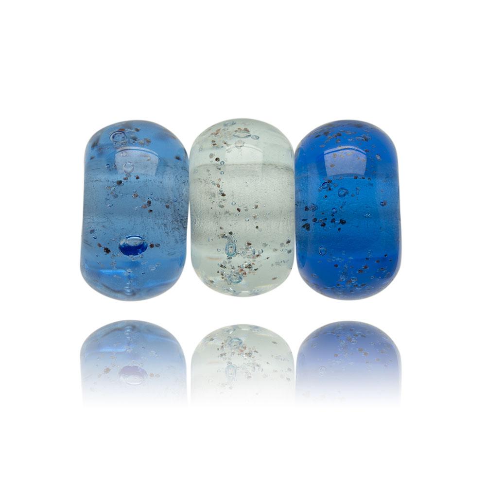 Blue trio of glass sand beads with grains of sand in the glass.
