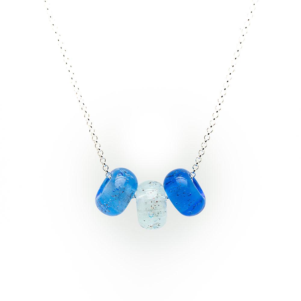 Blue trio of glass sand beads with grains of sand in the glass on a silver chain necklace.