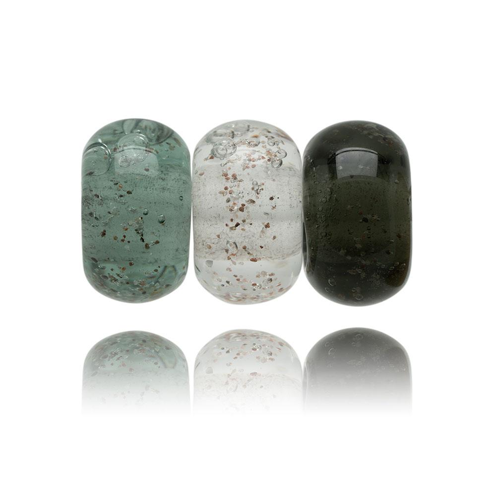 Grey trio of glass sand beads with grains of sand in the glass.
