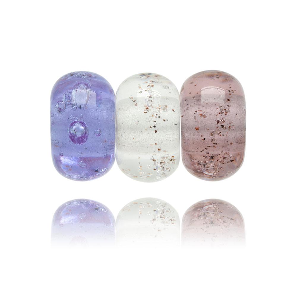 Pink trio of glass sand beads with grains of sand in the glass.