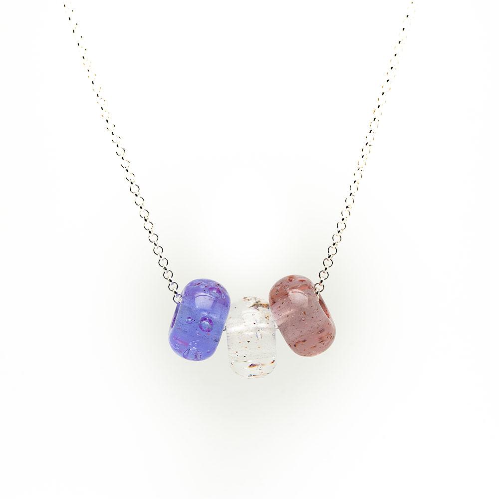 Pink trio of glass sand beads with grains of sand in the glass on a silver chain necklace.