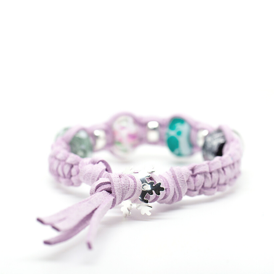 Lilac cord bracelet with silver snowflake fastener.