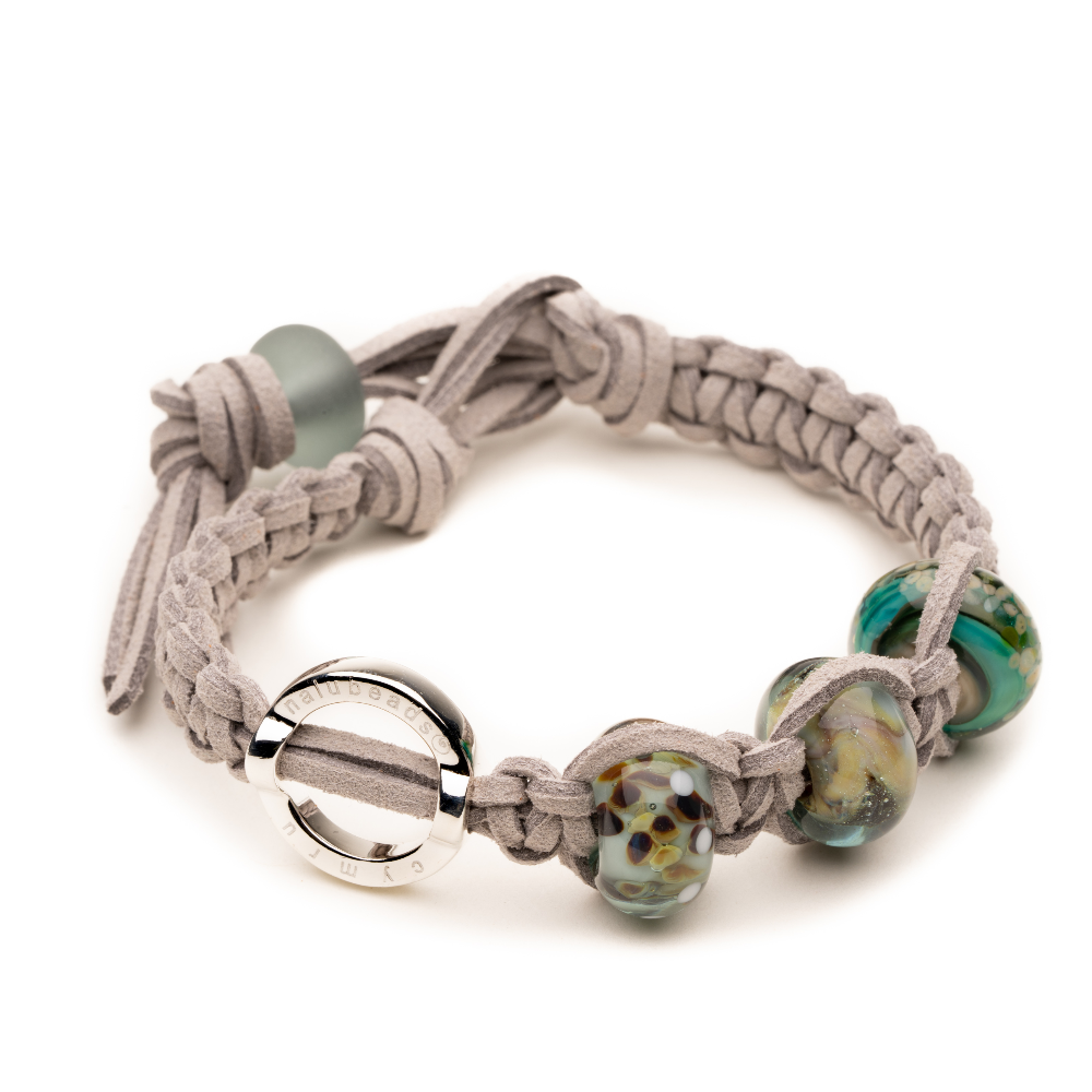 Grey cord bracelet with grey, green brown and silver glass beads.