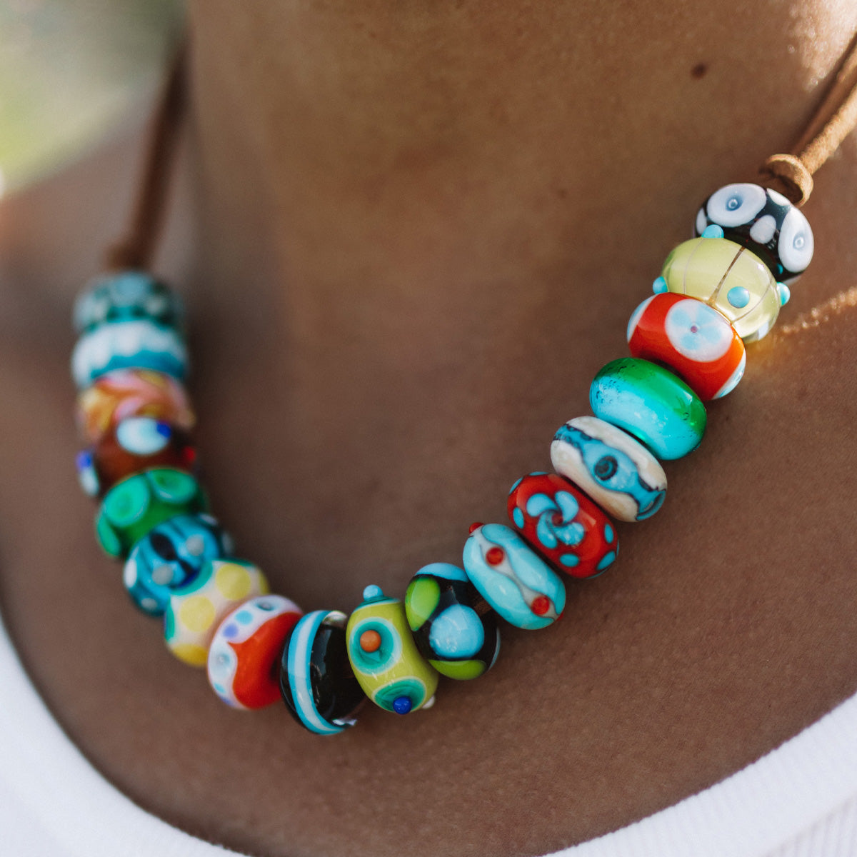 Colourful glass bead necklace representing worldwide travel destinations.