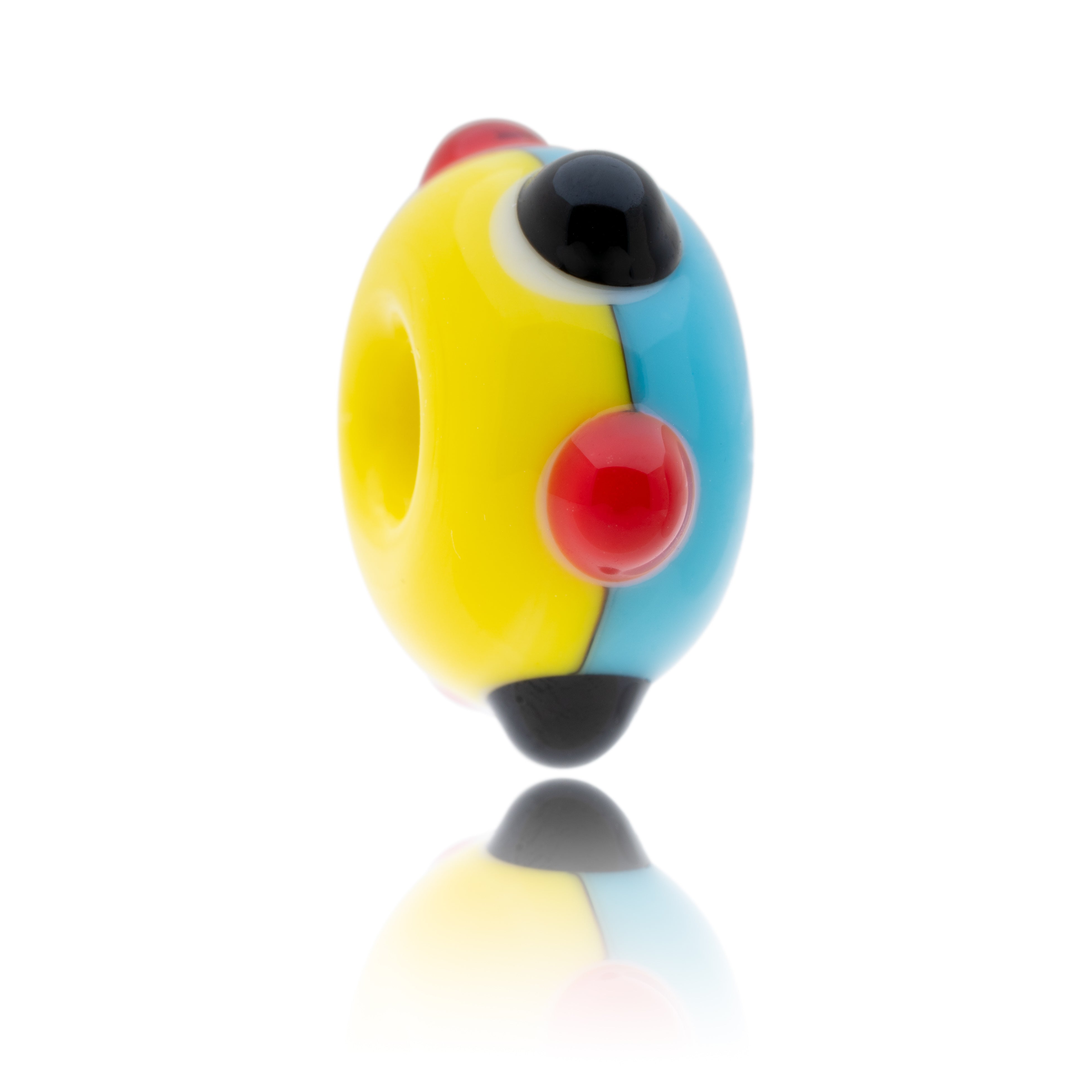 Yellow and blue glass bead with raised red and lack surface dots being sold to raise funds for the Amigos Charity.