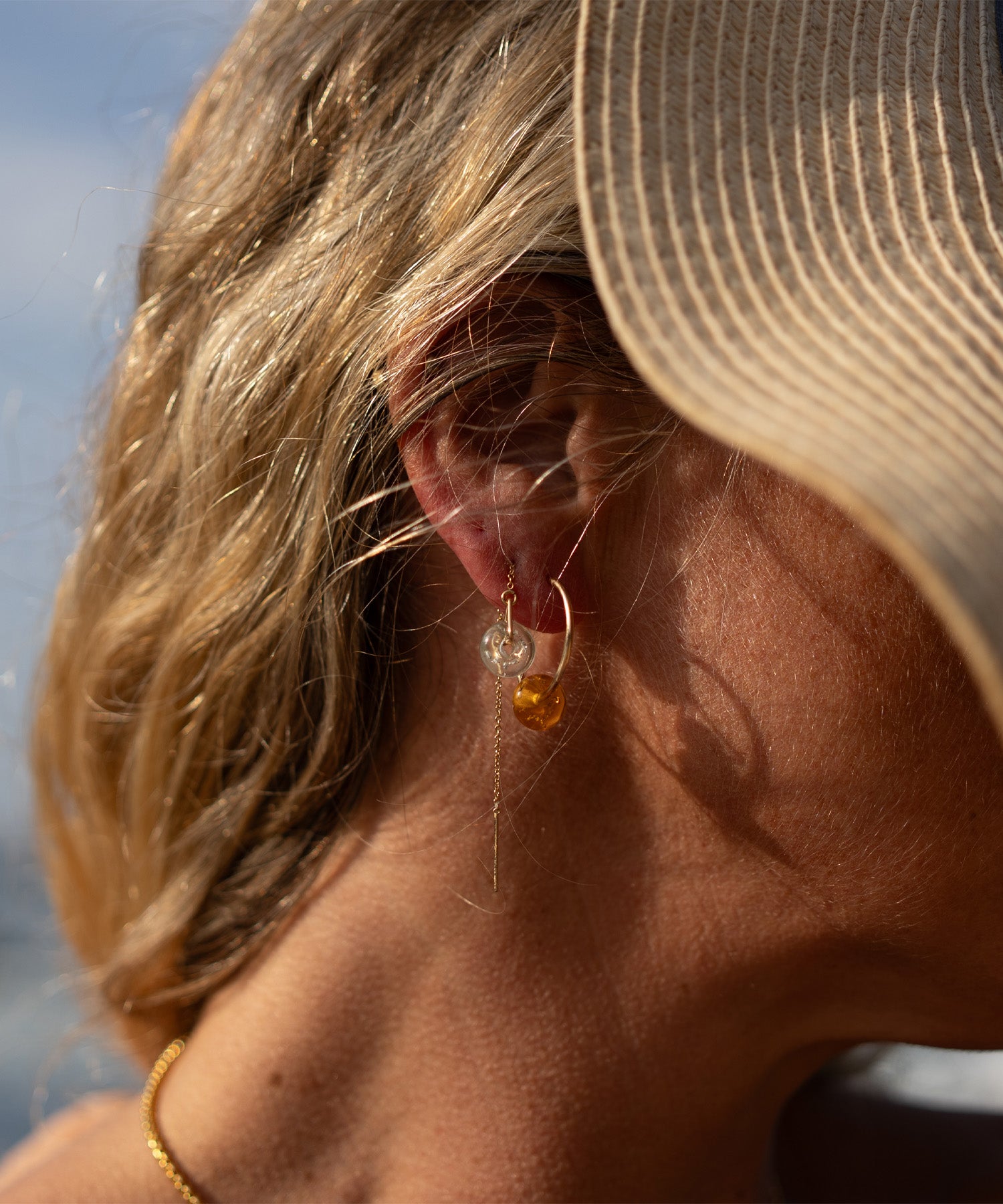 Close-up of a person wearing earrings with a blurred background