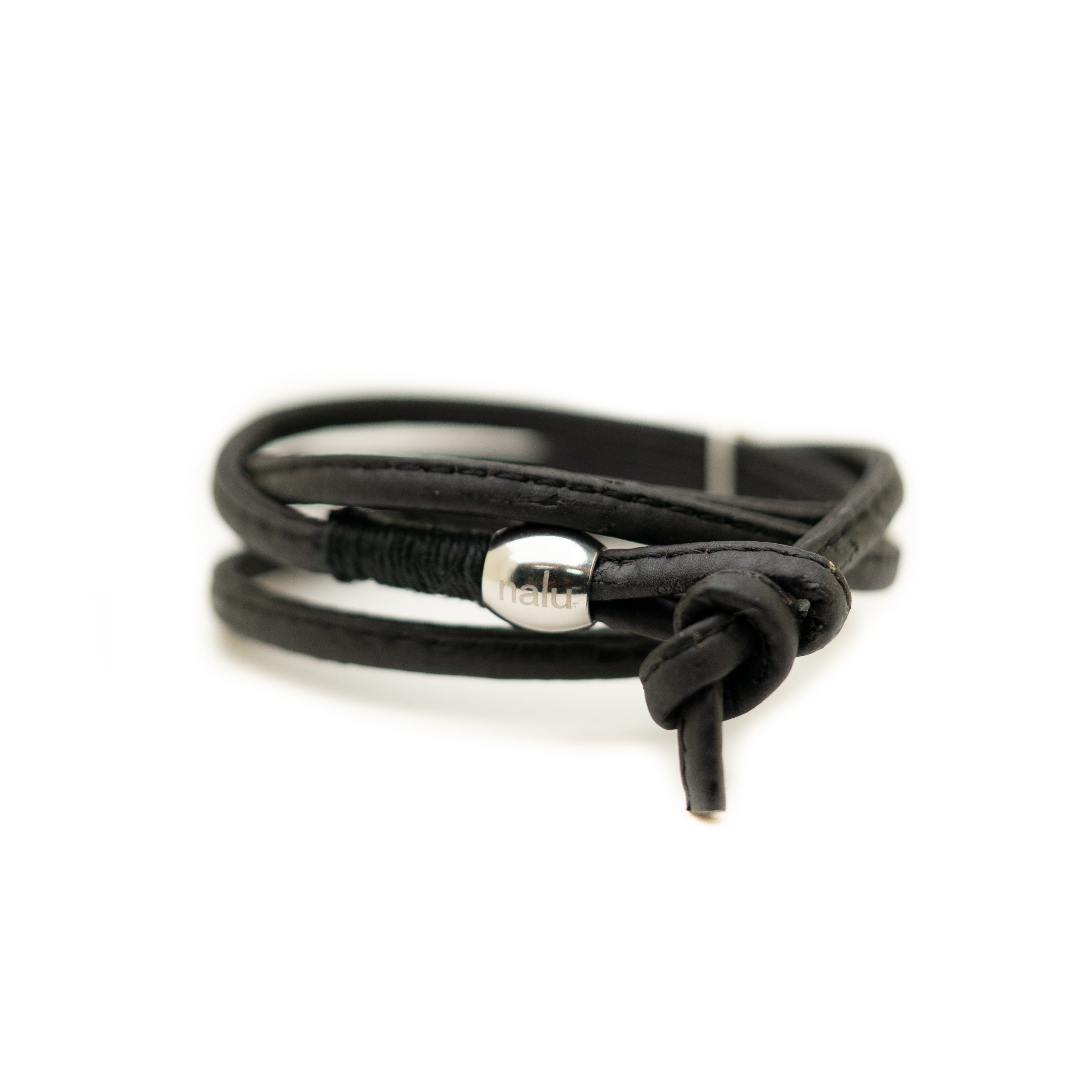 Black cork bracelet with a silver clasp on a white background