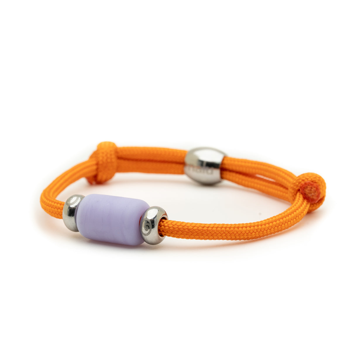 An orange braided cord bracelet featuring a central lavender purple cylindrical bead flanked by two polished silver metal spacer beads, shown on a clean white background.