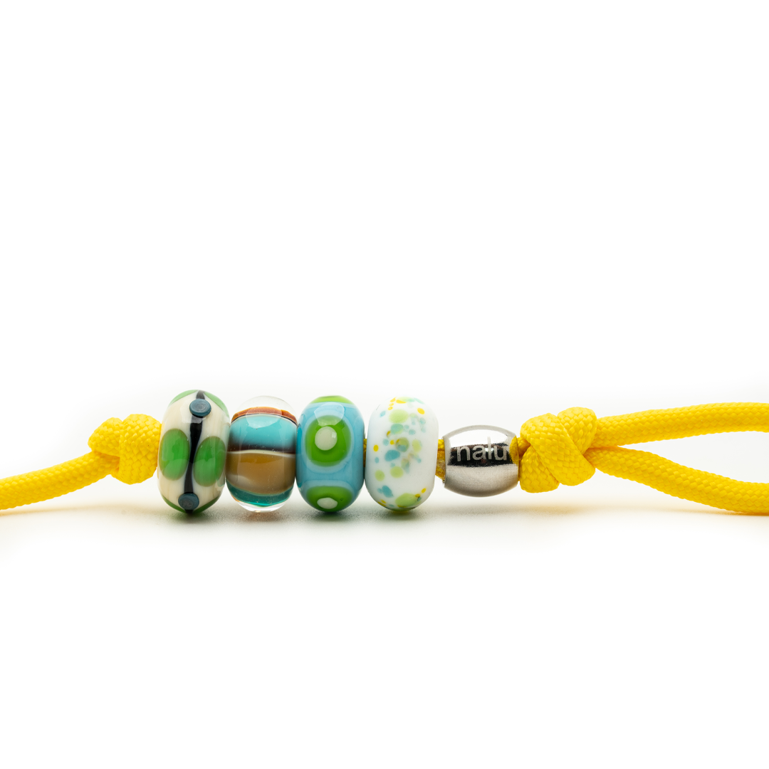 Keychain with colorful beads and a yellow cord on a white background